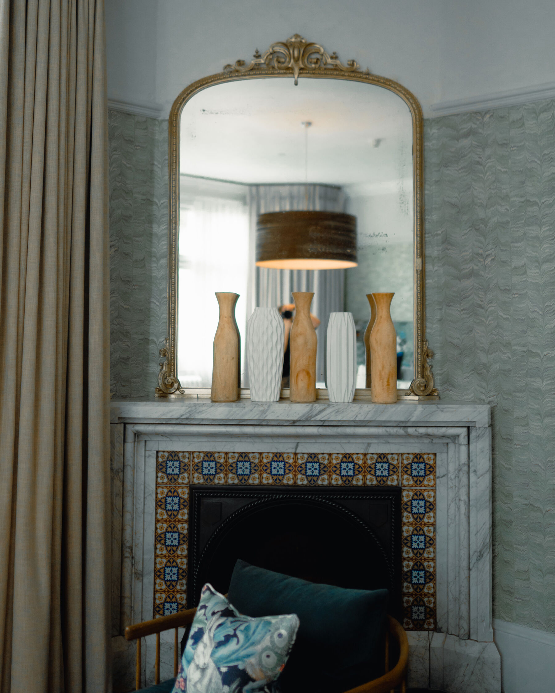 Hampton Manor: A Modern, Reimagined & Wildly Romantic Wedding Venue 11 Hampton Manor bedroom fireplace with tall gold gilt edged mirror on the mantelpiece.