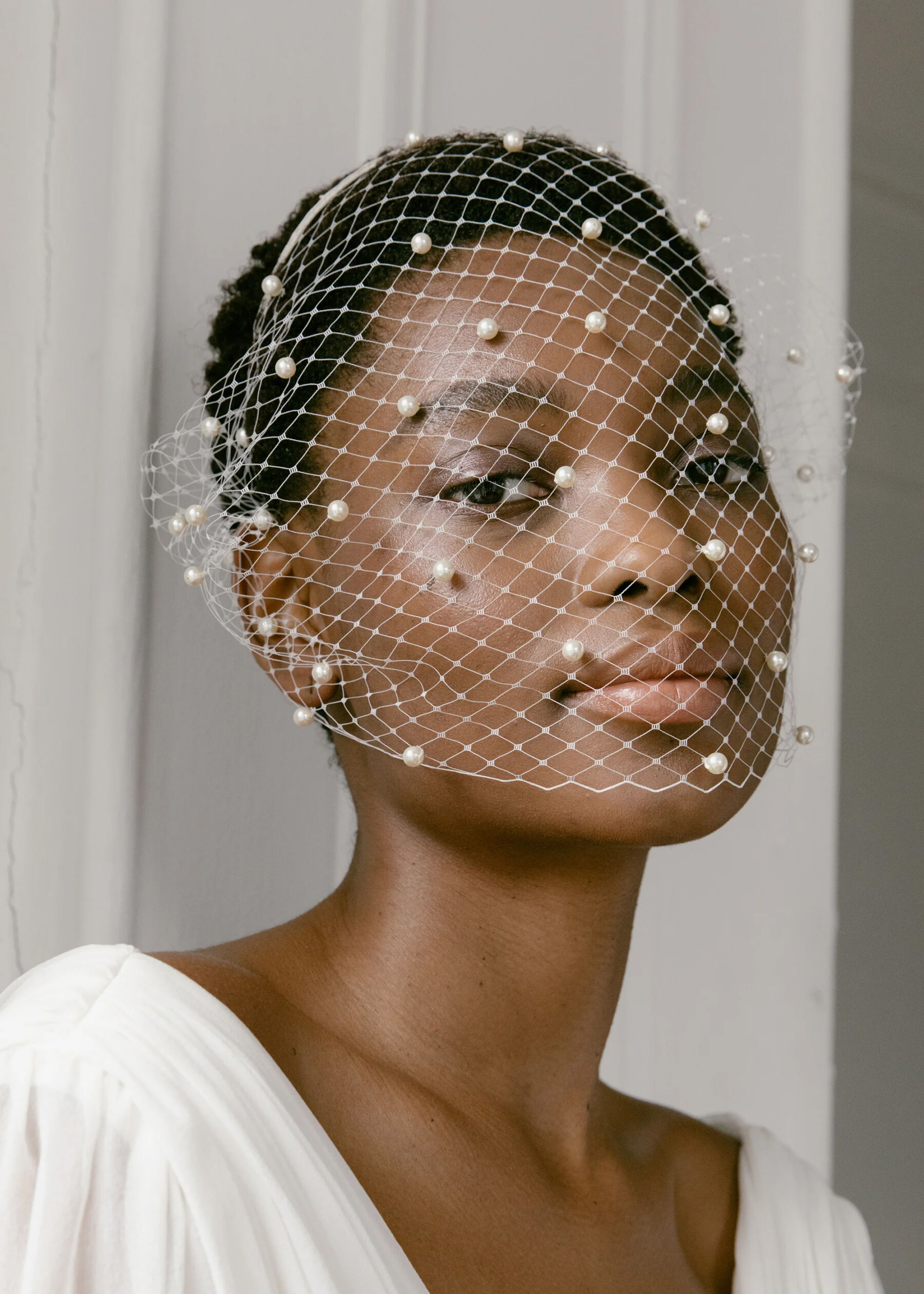 Black bride wearing a Jennifer Behr Pearl Birdcage Veil