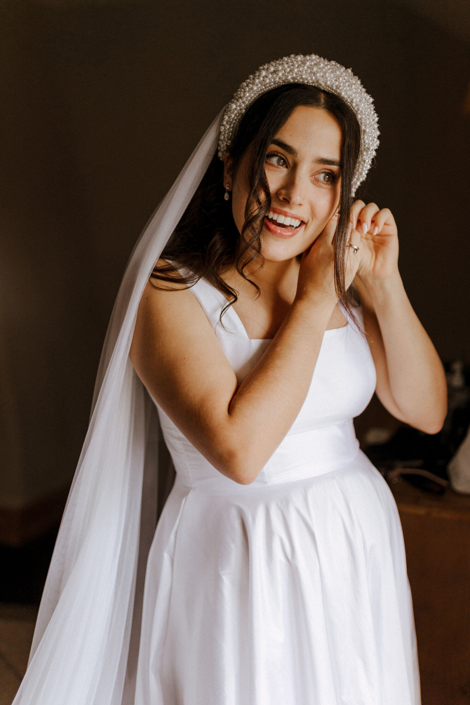 Bride wearing a pearl headband, veil and a Jessica Bennett wedding dress.