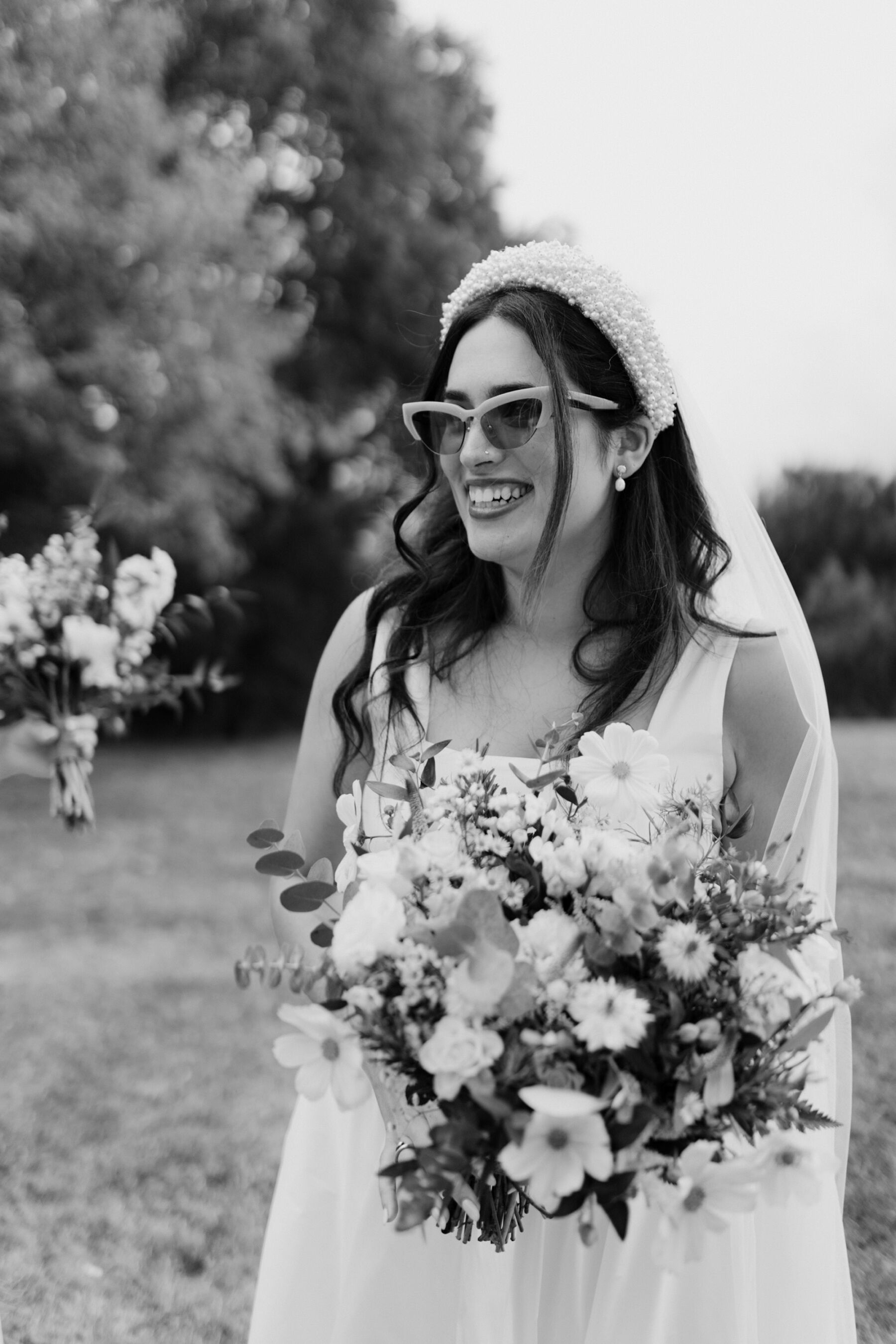 Cool bride wearing a pair of sunglasses.