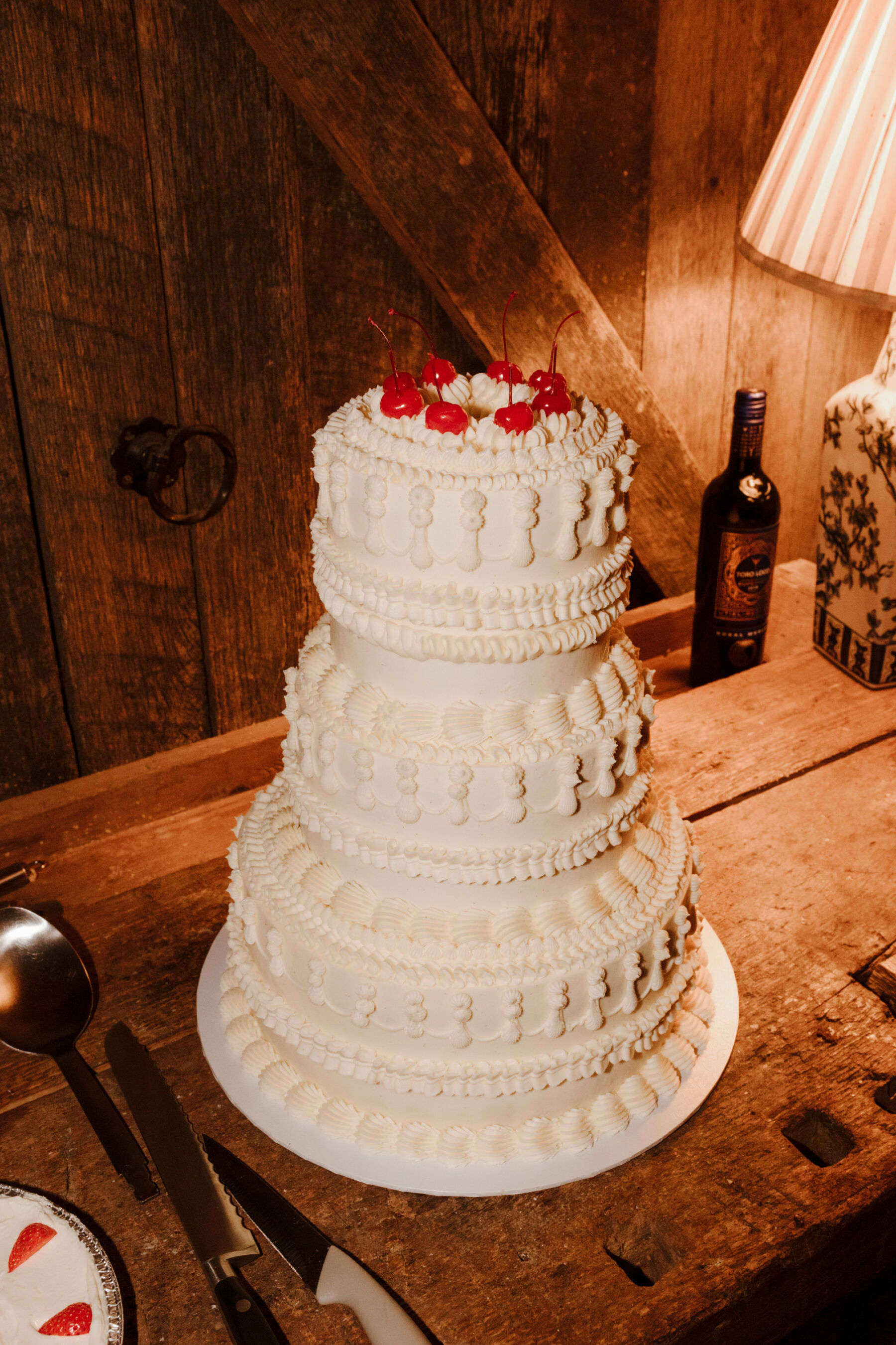 Camp and retro wedding cake topped with cherries.