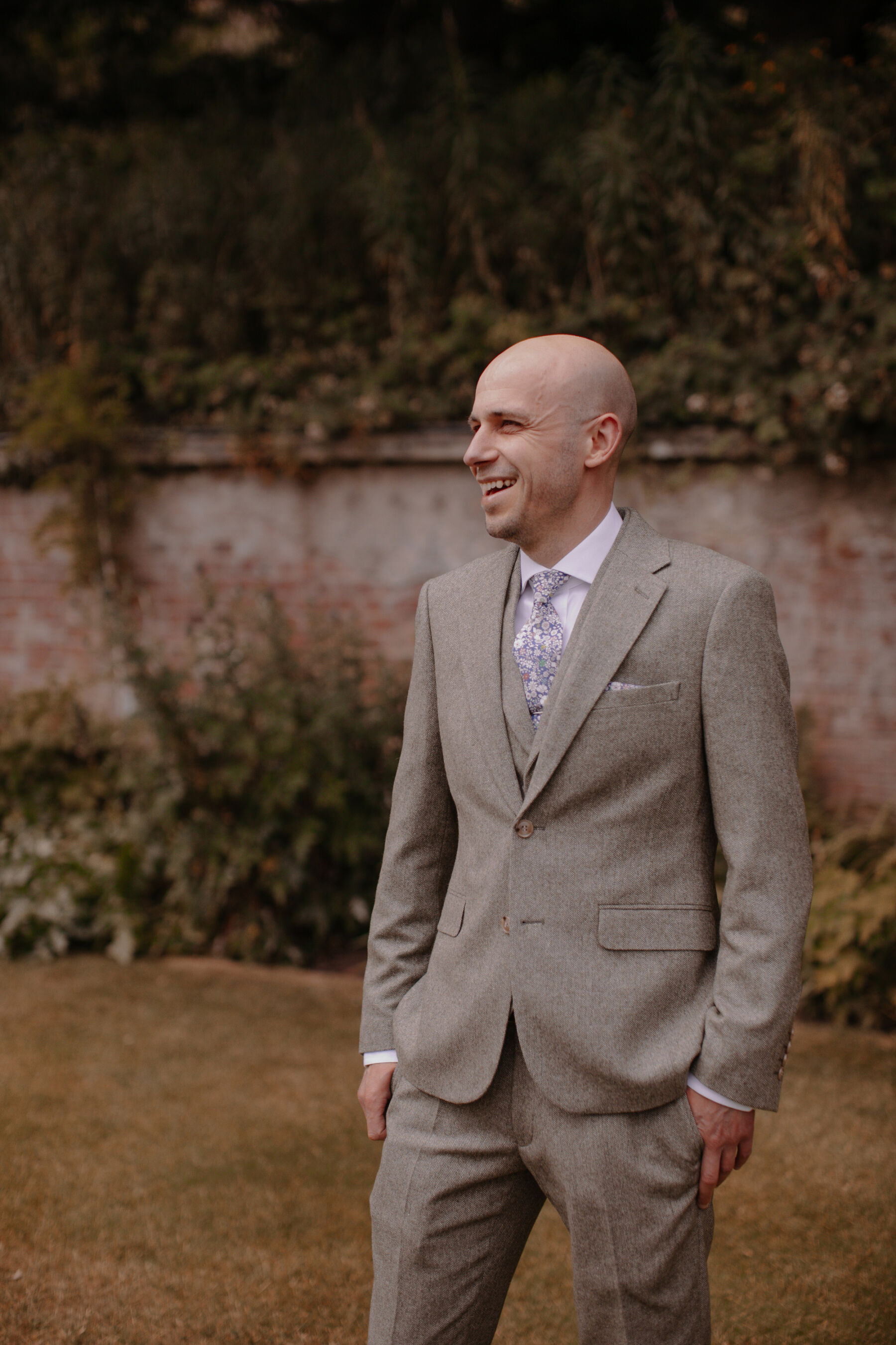 Groom in pale grey suit from Moss Bros