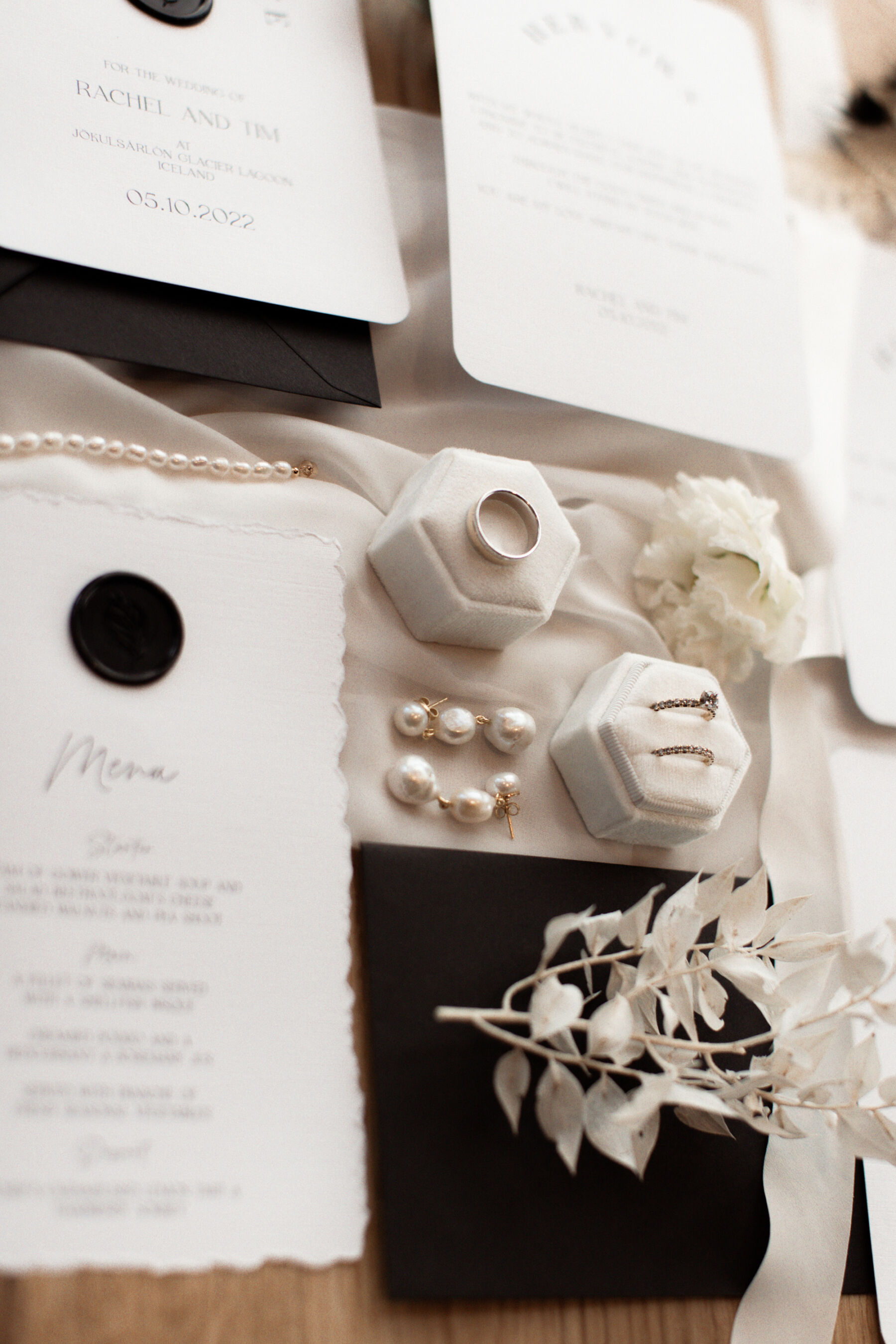 Modern white wedding stationery with bleached flowers