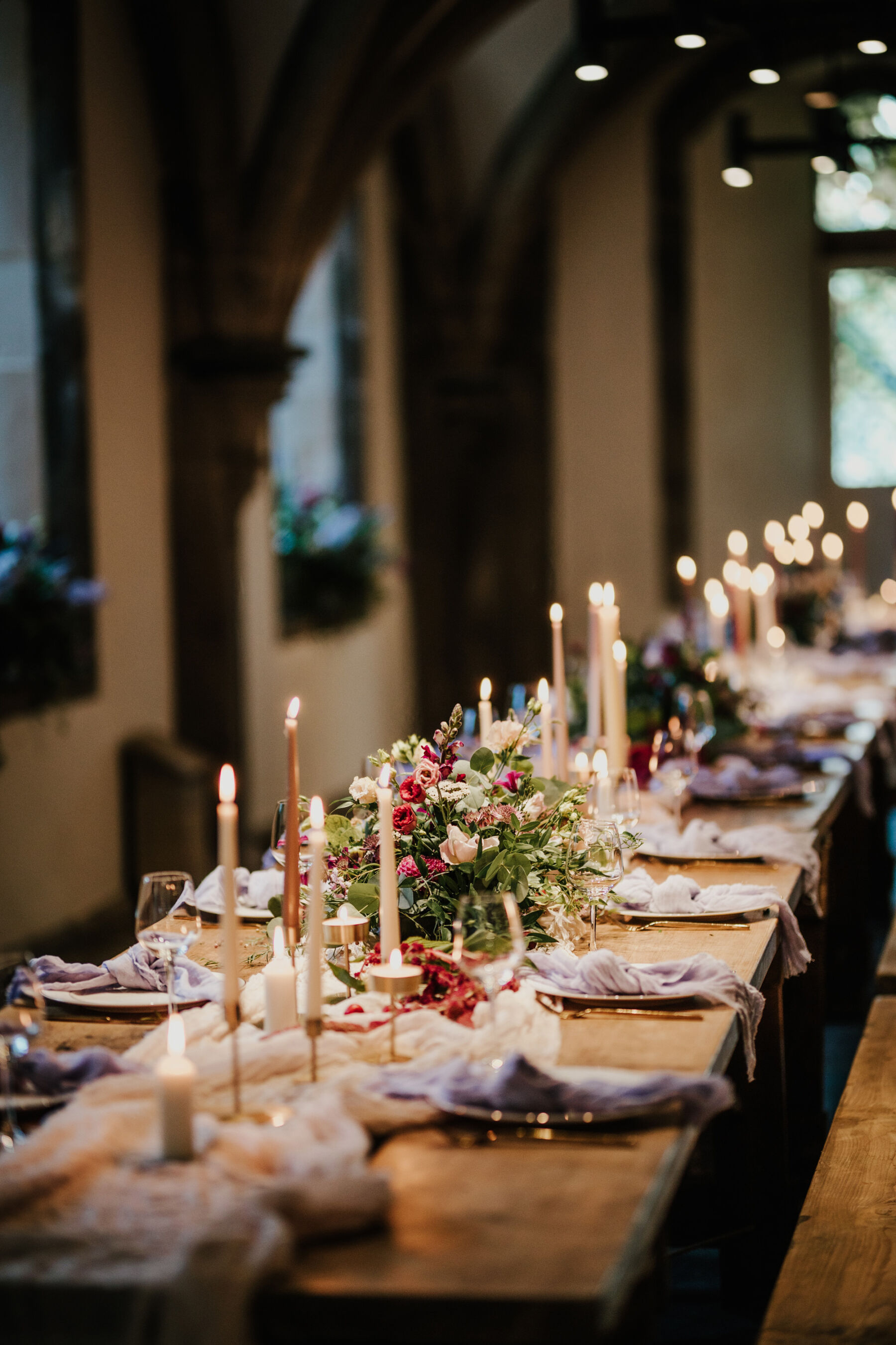 Romantic candlelit table with taper candles and linens at Bishop's Palace historic wedding venue in Wells, Somerset.