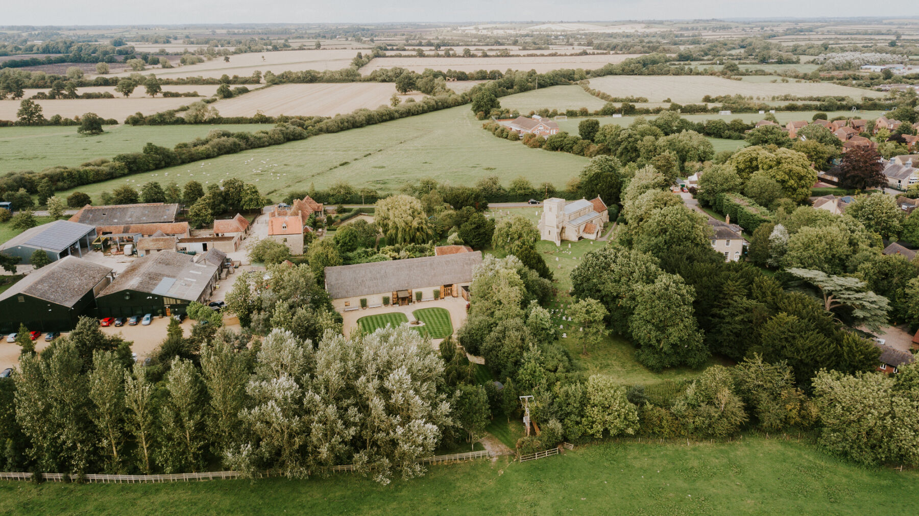 Drone view of Tythe, barn wedding venue in Oxforsdhire South East UK, surrounded by miles of English countryside.