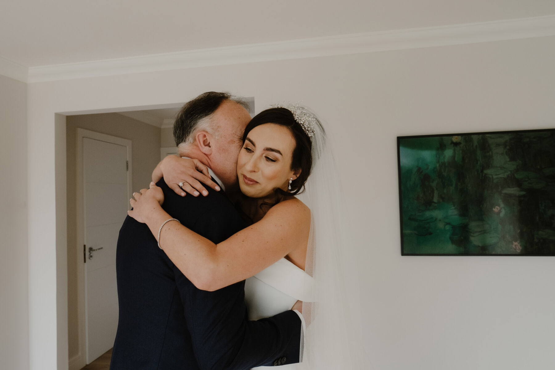 A Modern & Minimalist Phillipa Lepley Bridal Gown for her Classy & Elegant Spring Wedding at The Gleneagles Hotel 12 Bride hugging her father.