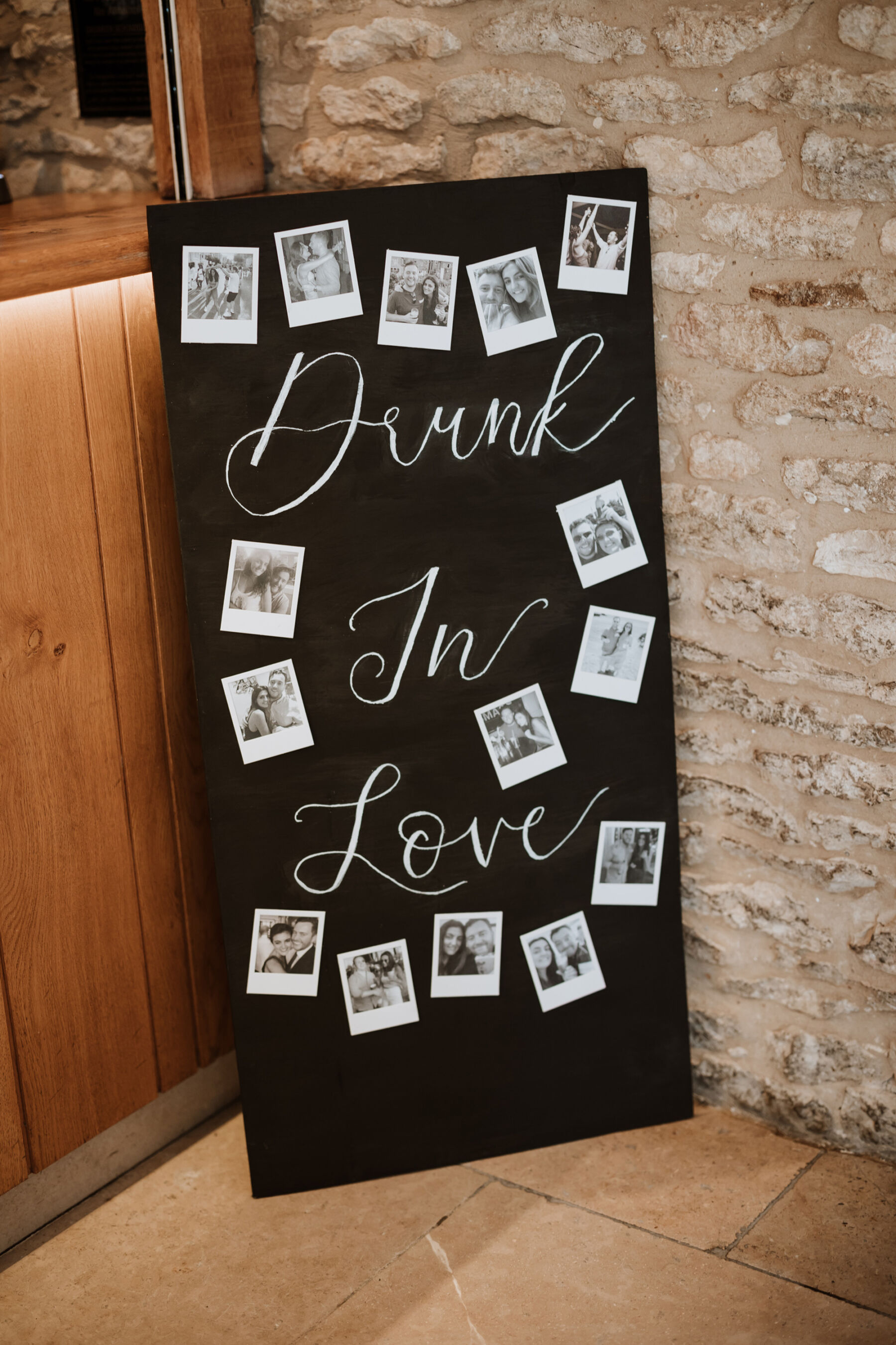 Sophie in Rime Arodaky for her Elegant Caswell House Wedding in The Cotswolds 30 Drunk in Love wedding sign with polaroid images