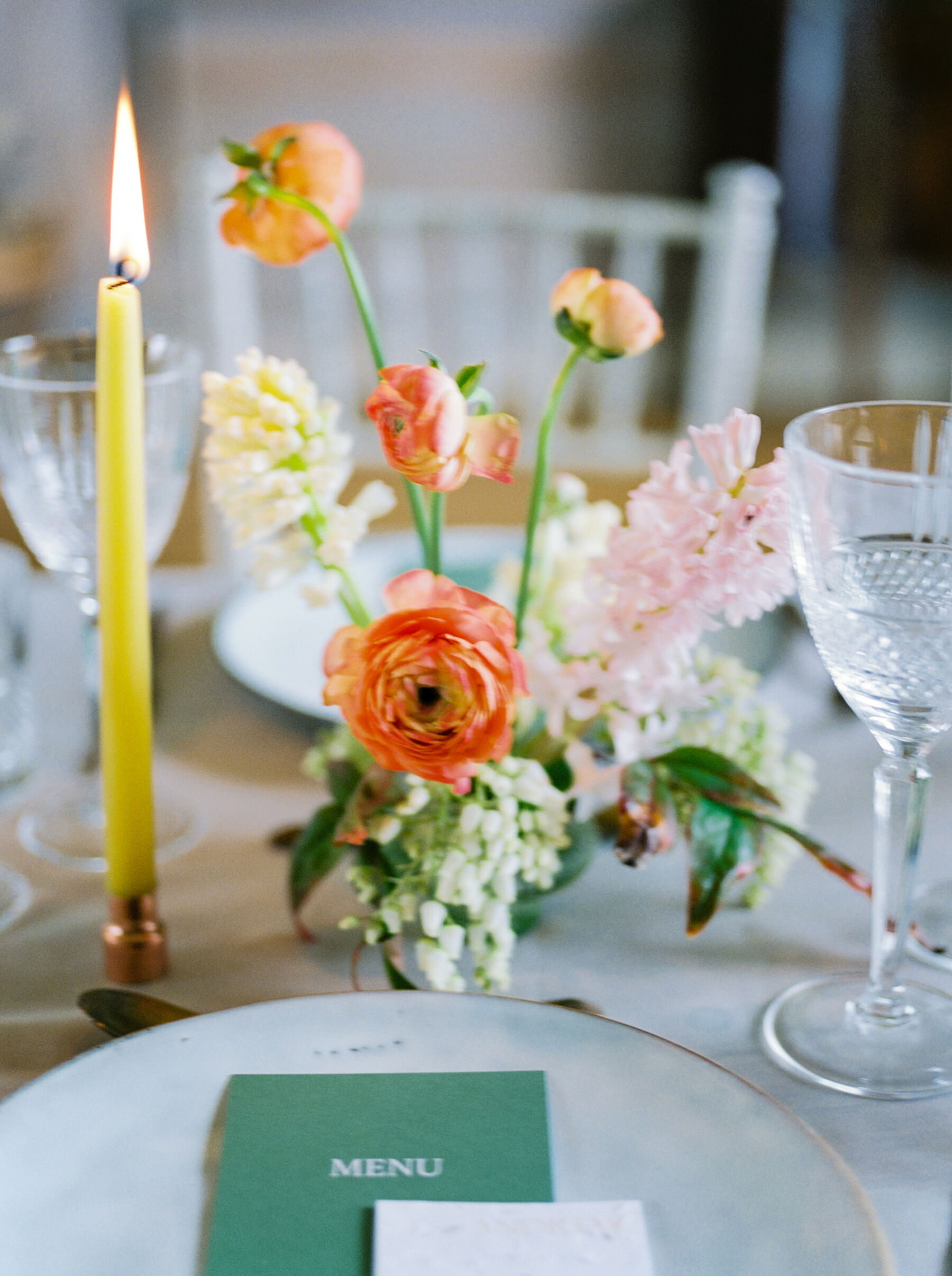 Dlegant tall chartreuse coloured tapered candles + bright and colourful British grown wedding flowers.