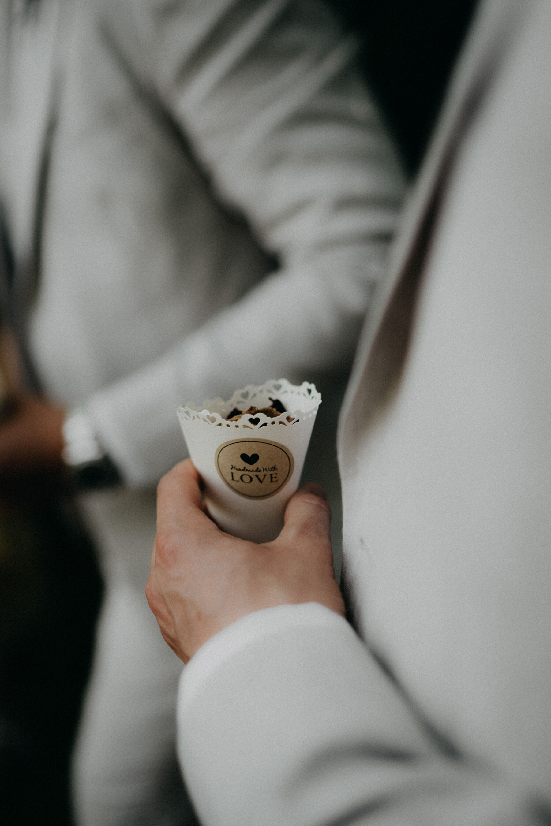 Emily in a Bespoke Halterneck Gown for her Elegant Chateau De Puissantut Wedding in South West France 21 Groomsmen holding a paper cone full of confetti.