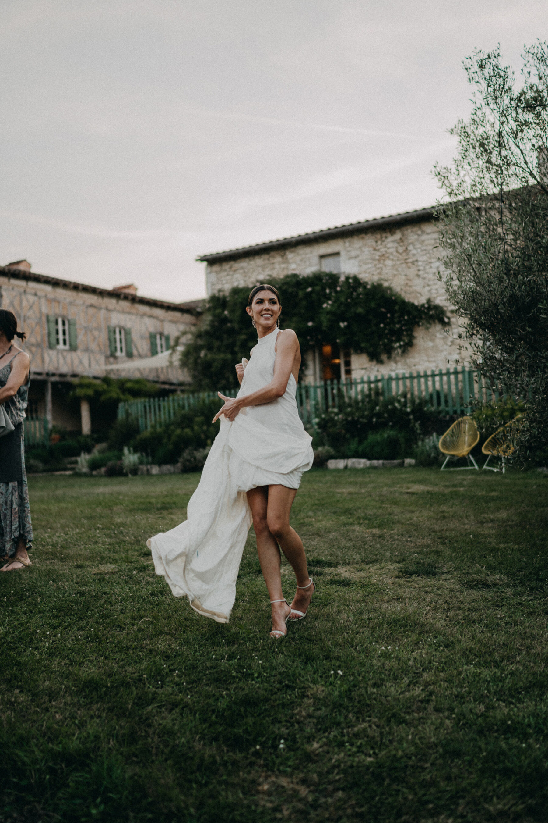 Bride in a halterneck wedding dress flashing her thigh. 