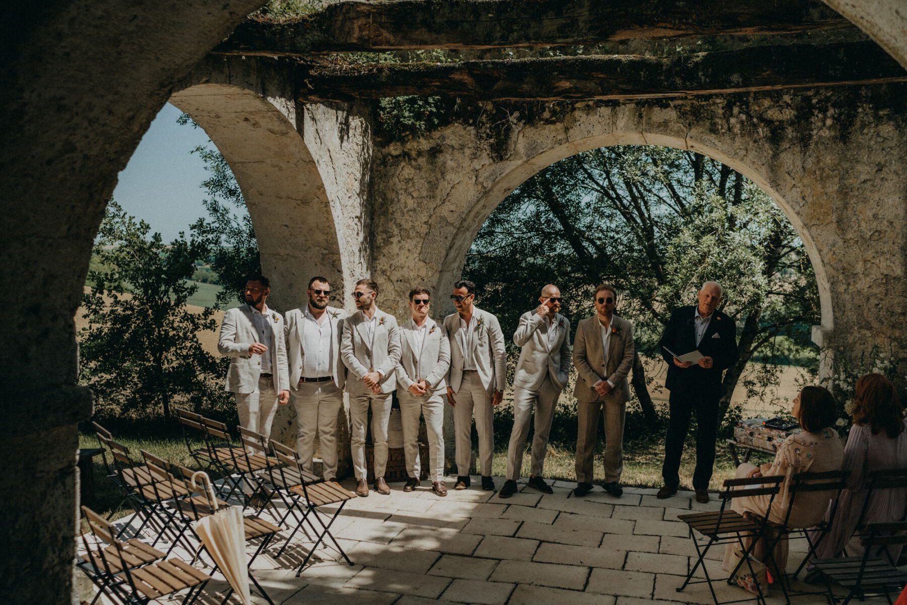 Groom and groomsmen in pale suits.