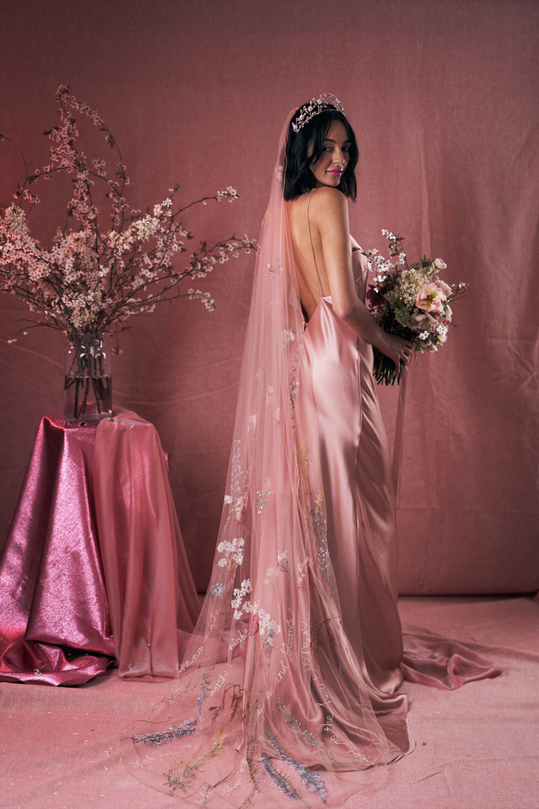 Pink wedding dress by Kate Beaumont. Embroidered pink veil by Daisy Sheldon.