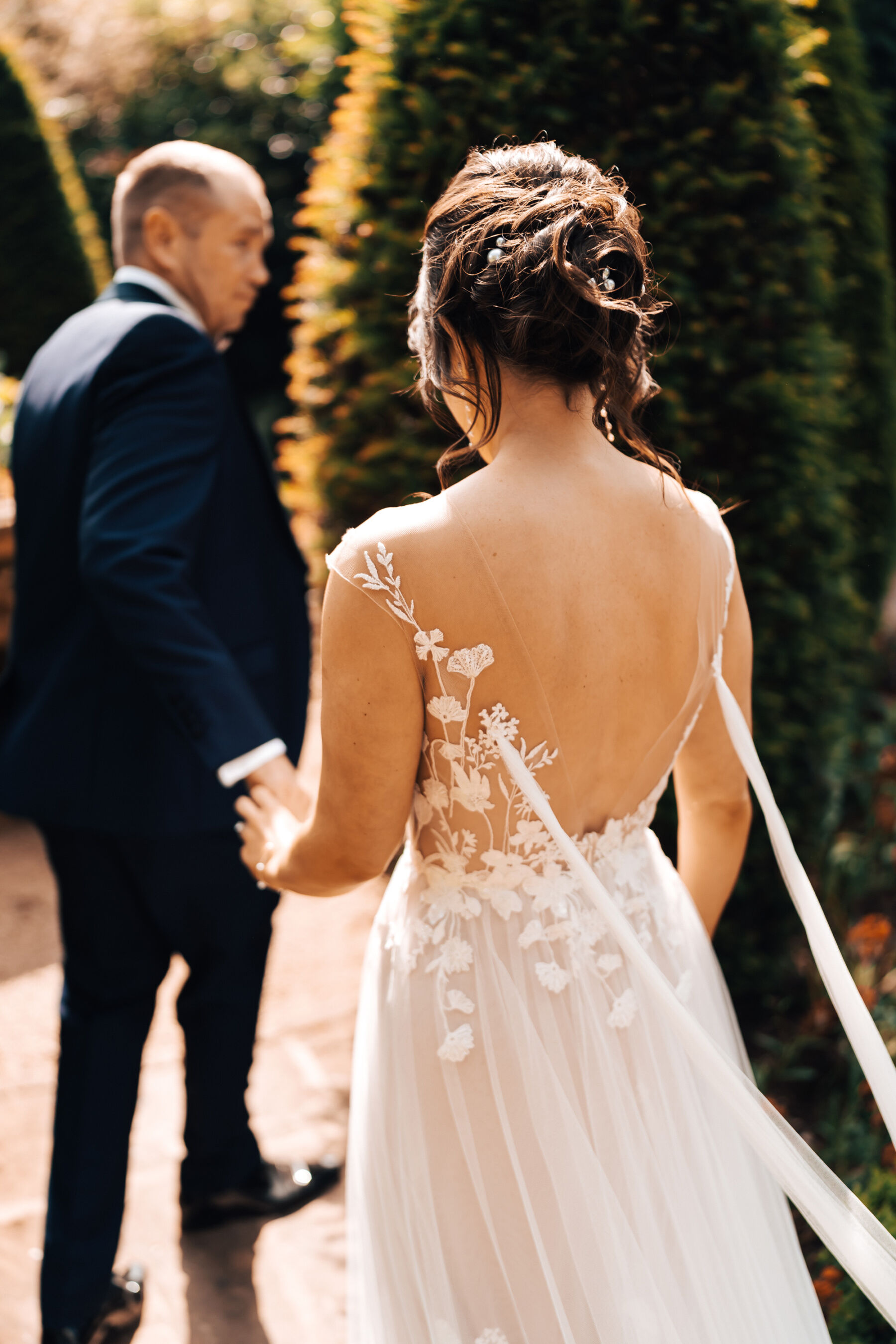 Bride in a backless Anna Kara dress at Tythe Barn wedding venue in the Cotswolds.