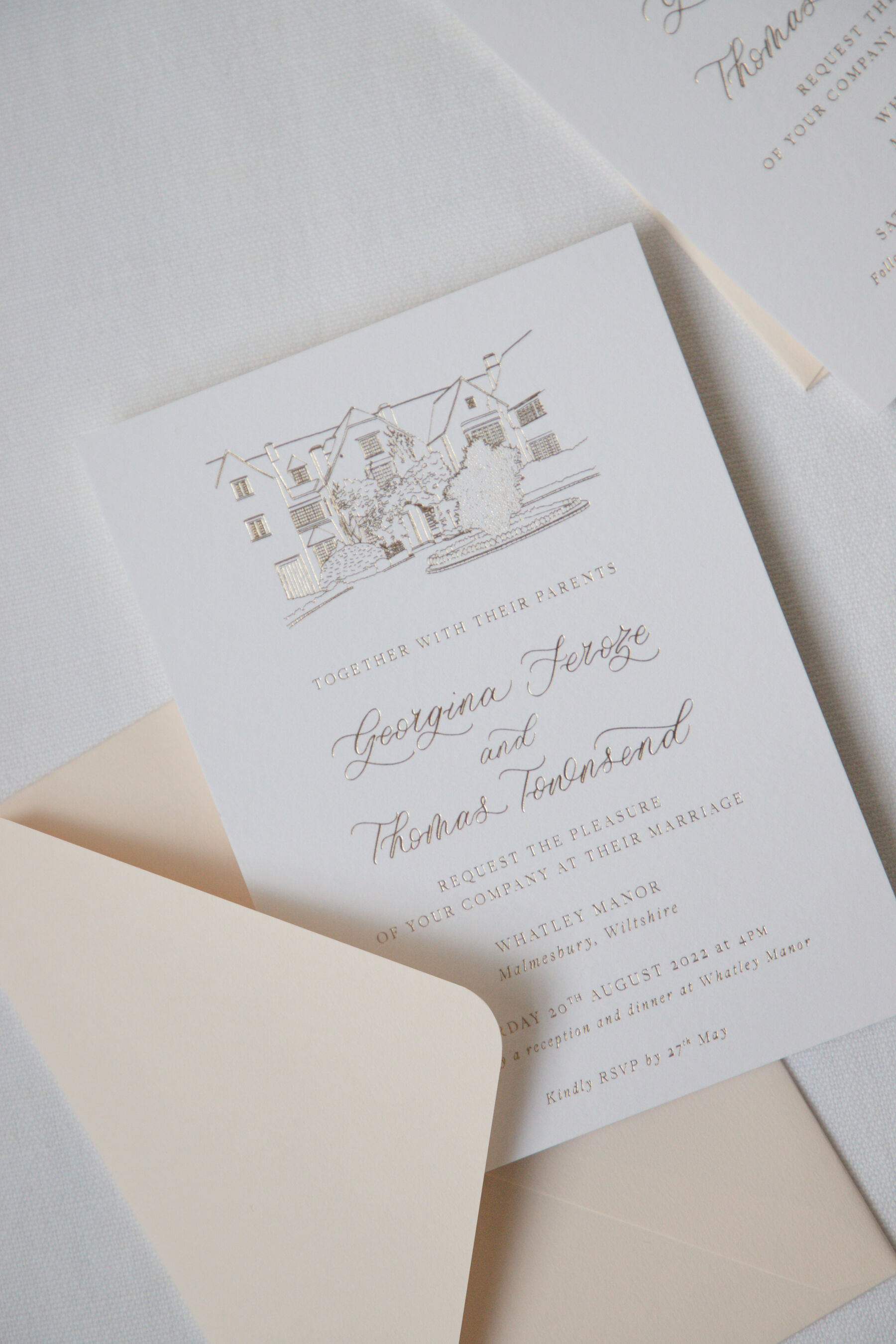 Bespoke hot foil printed wedding invitation with venue illustration and calligraphy details.