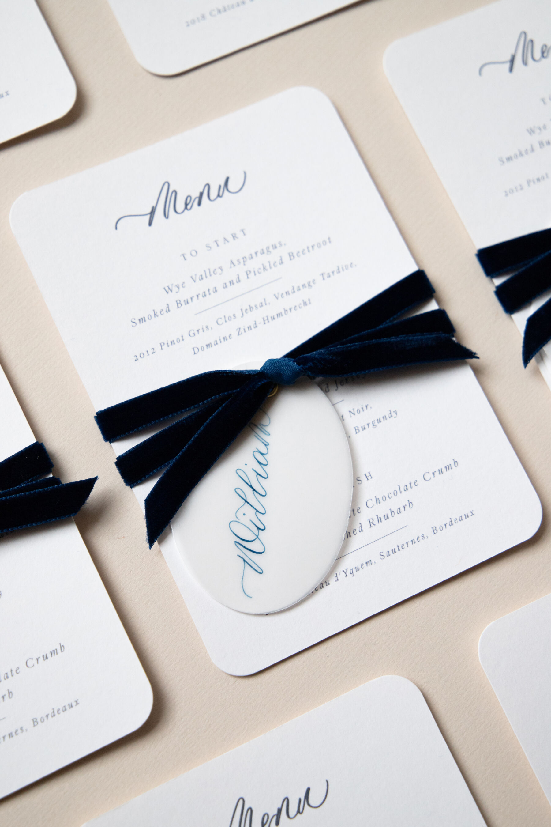Bespoke menu card with calligraphy place tag.
