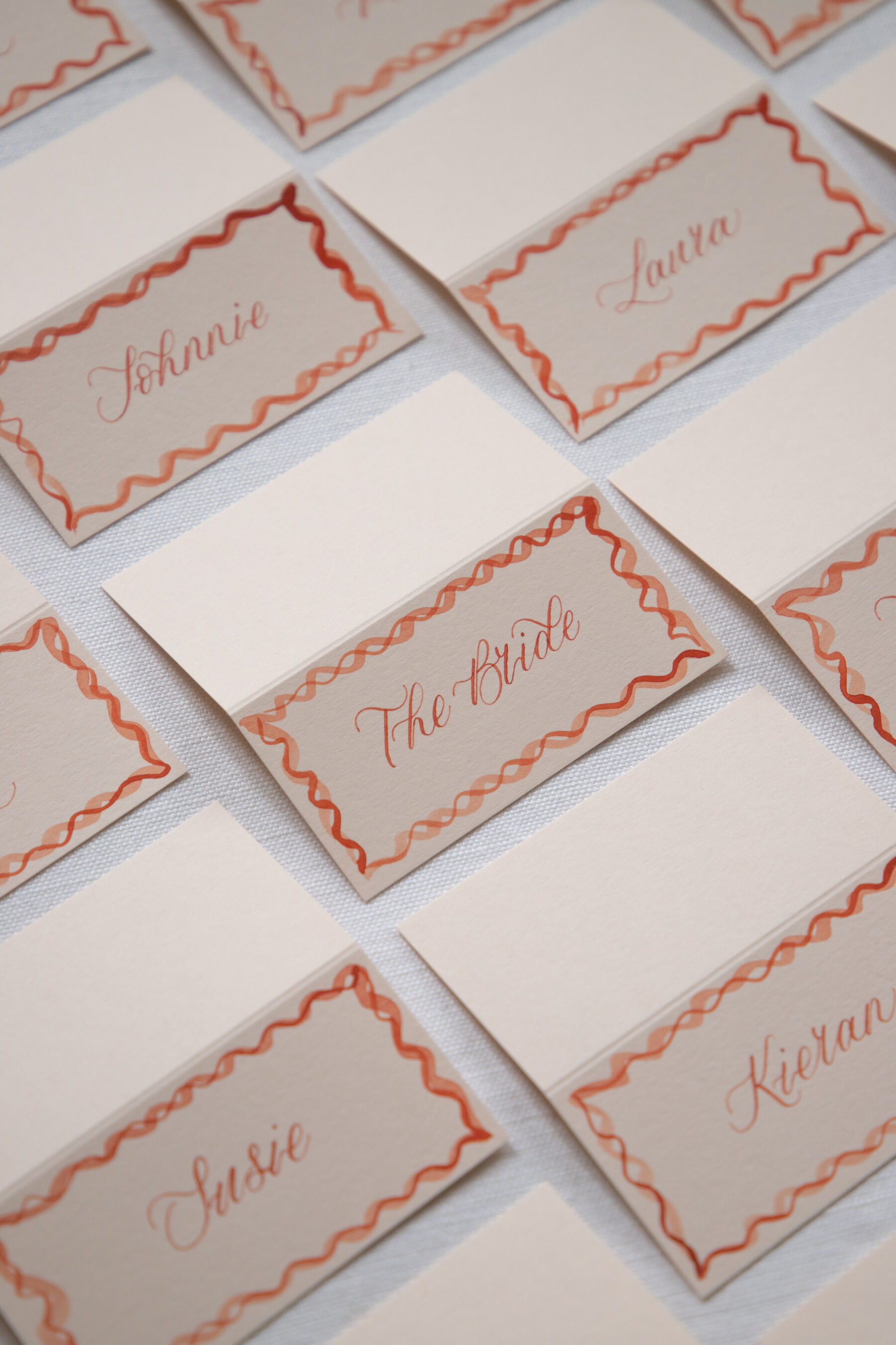 Calligraphy place cards with two colour watercolour borders  