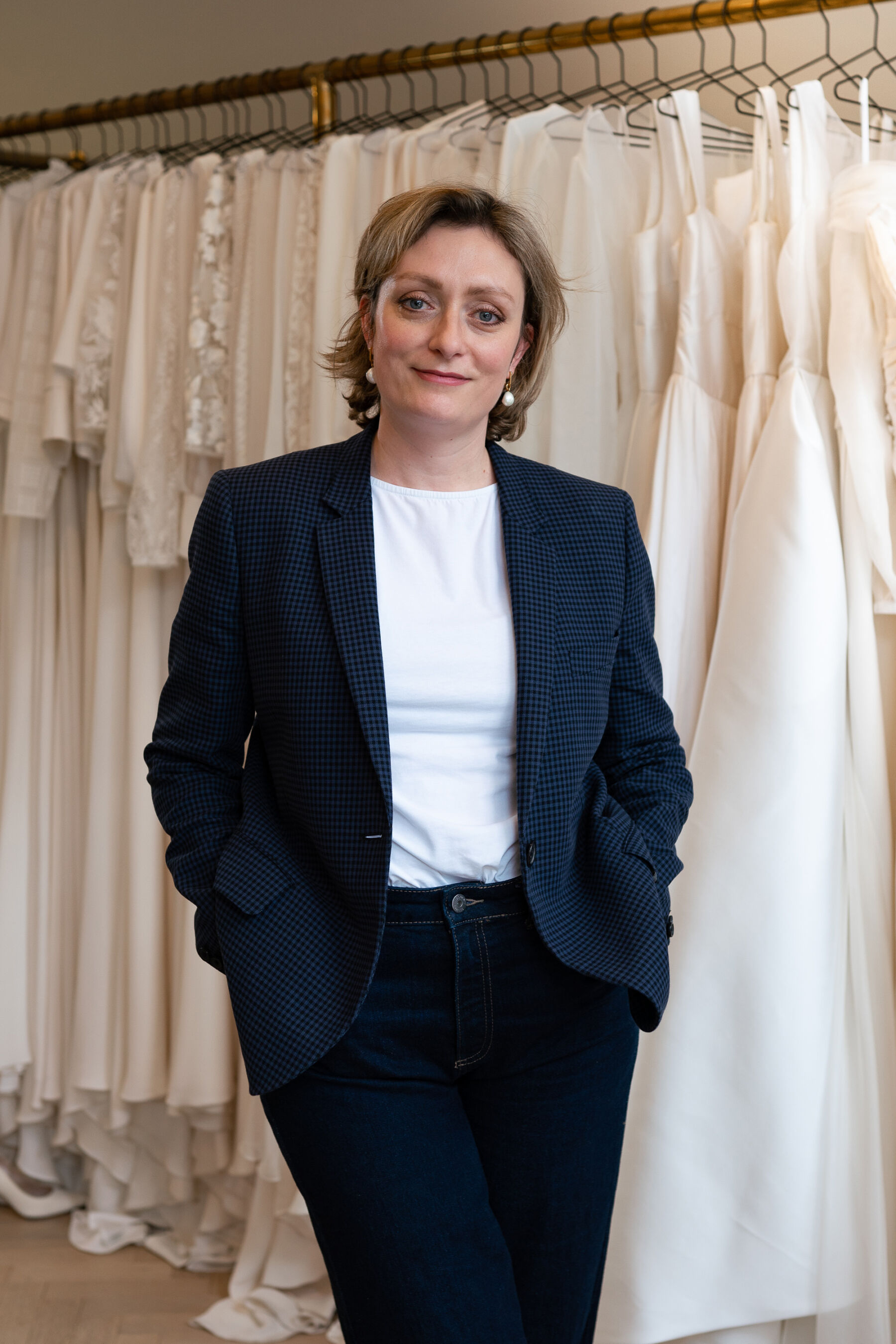 Designer Andrea Hawkes Bridal standing in her boutique in London
