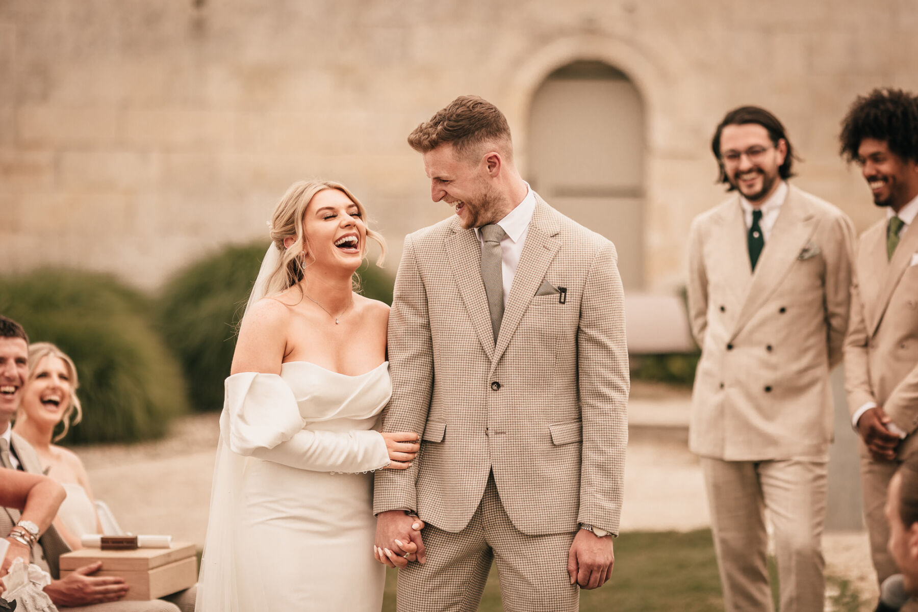 Bride in Enzoani wedding dress smiling during her outdoor ceremony in France