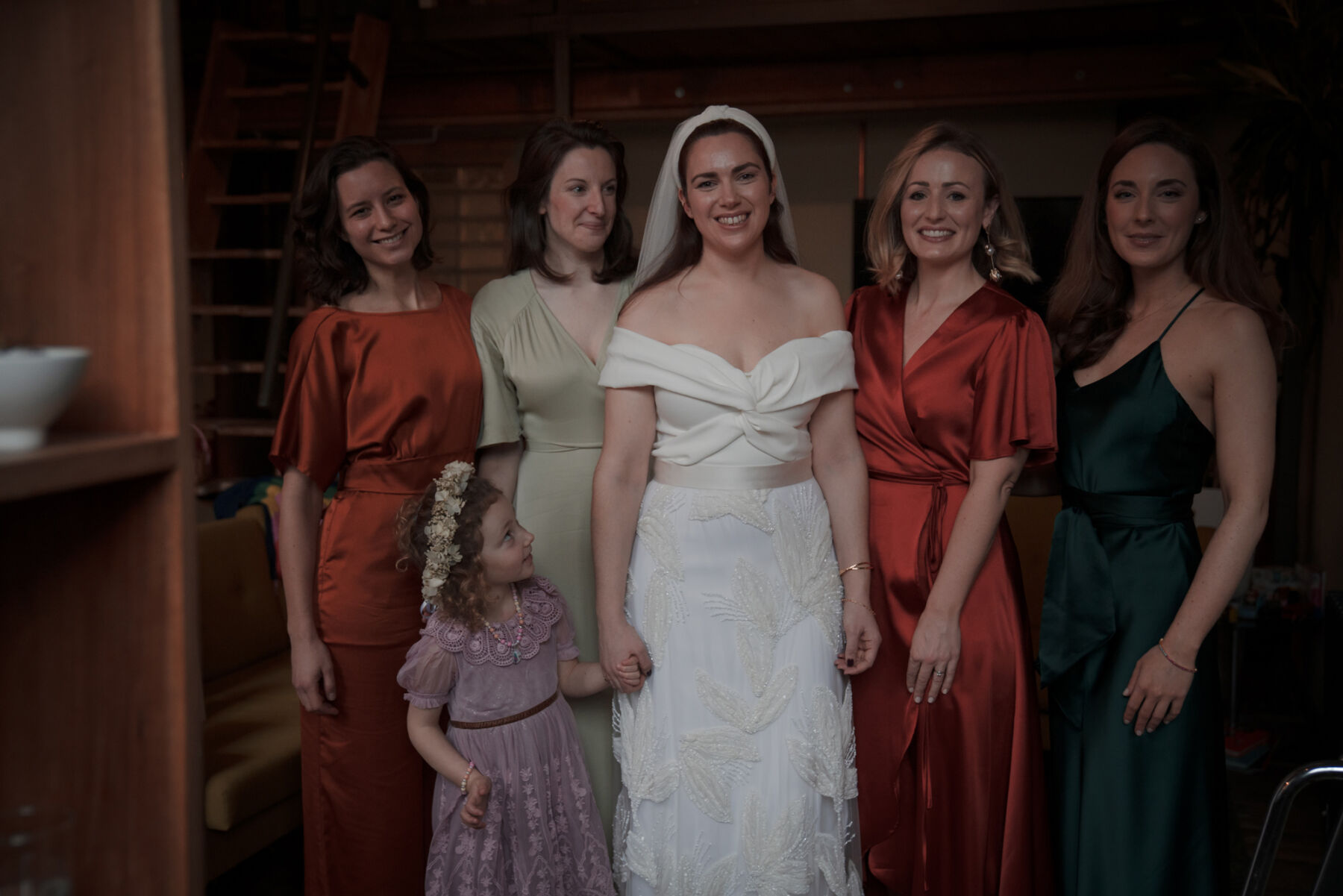 Bridesmaids in burnt orange and bottle green