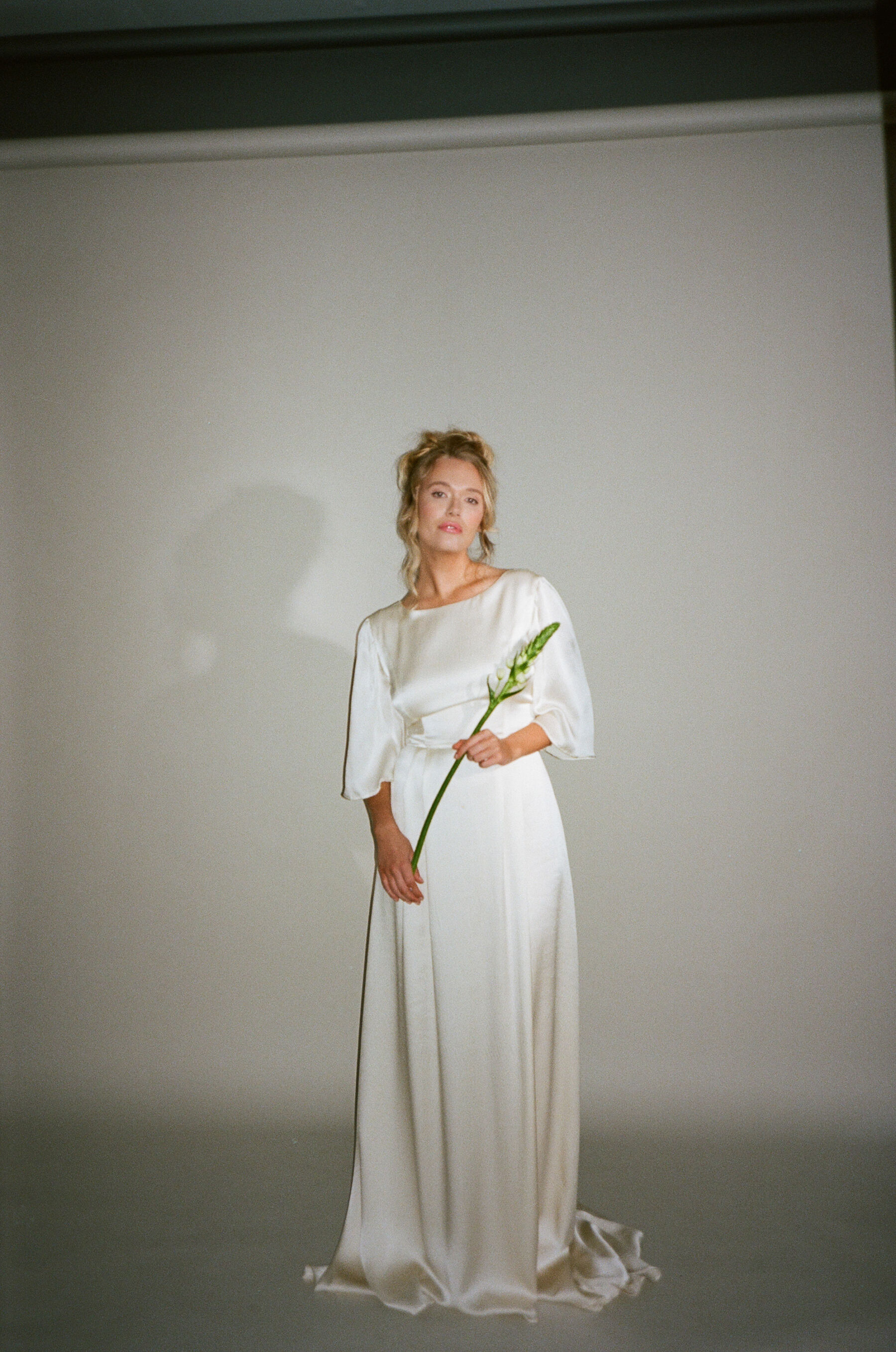 Analogue photograph of model bride wearing a Kate Beaumont silk wedding dress.