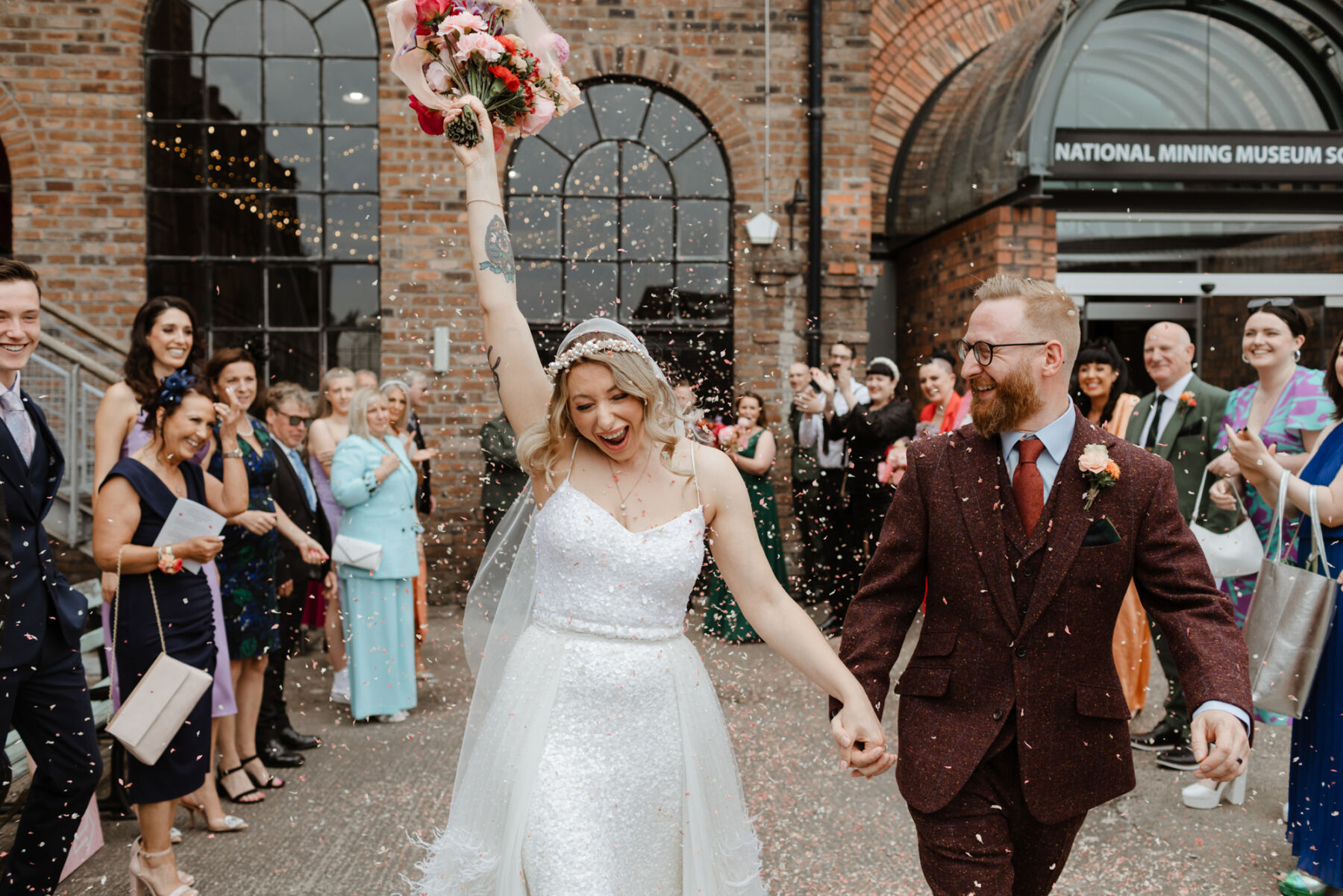 Bride and groom joyful colourful confetti shot