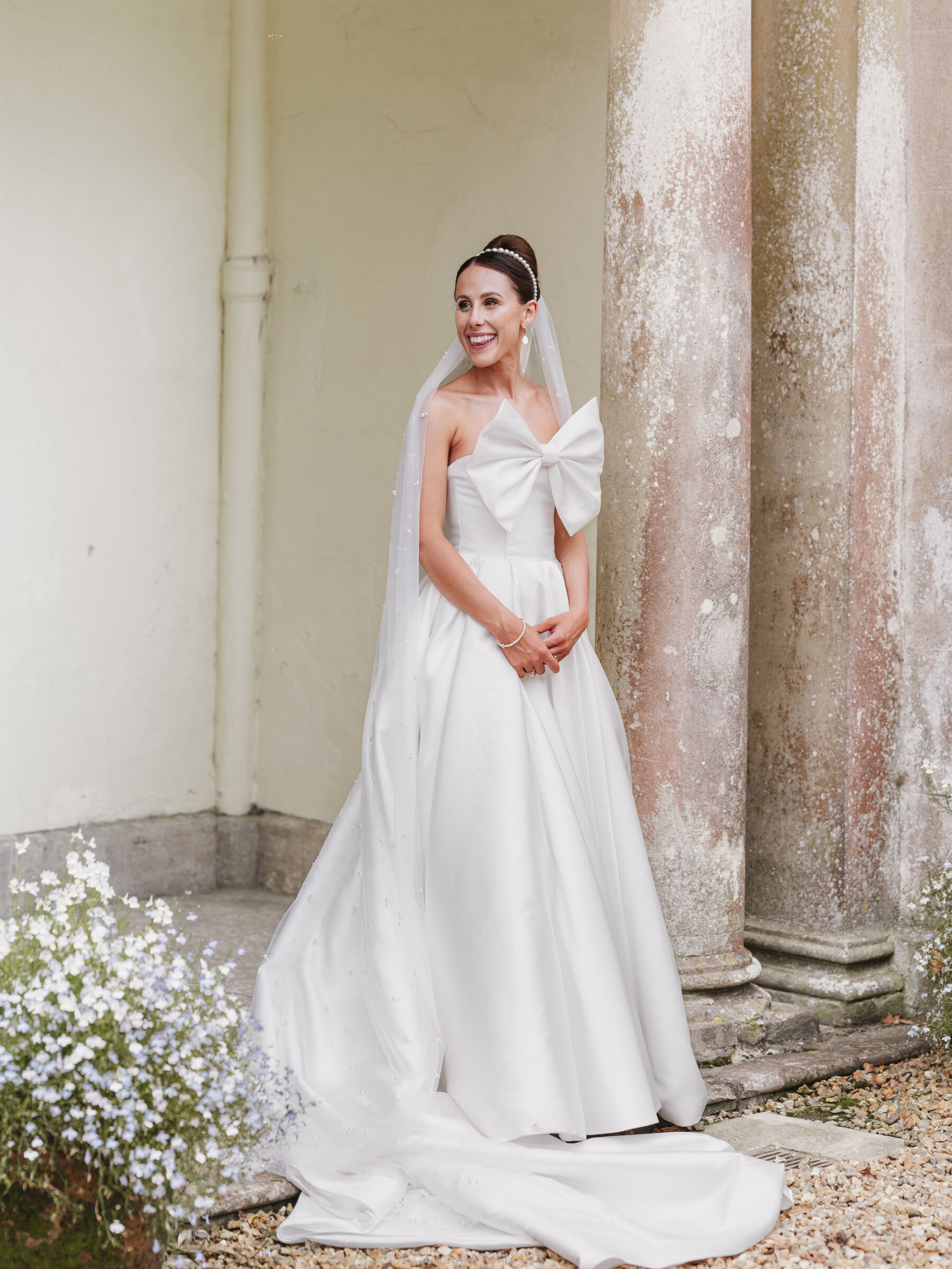 Elegant bride wearing a big bow wedding dress
