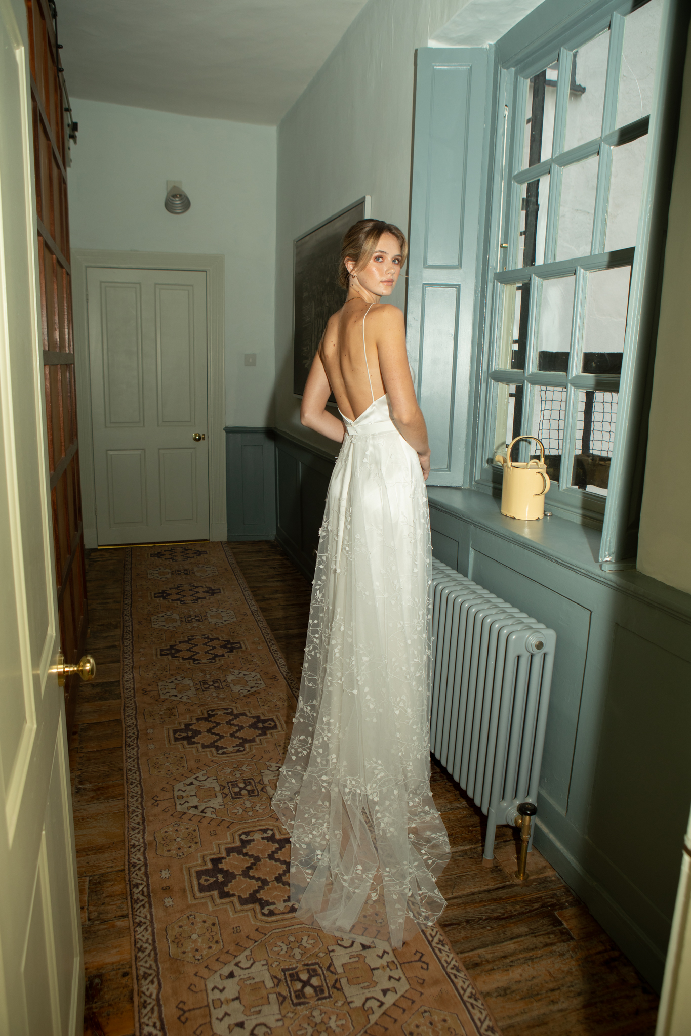 Backless modern wedding dress with spaghetti straps by Andrea Hawkes Bridal