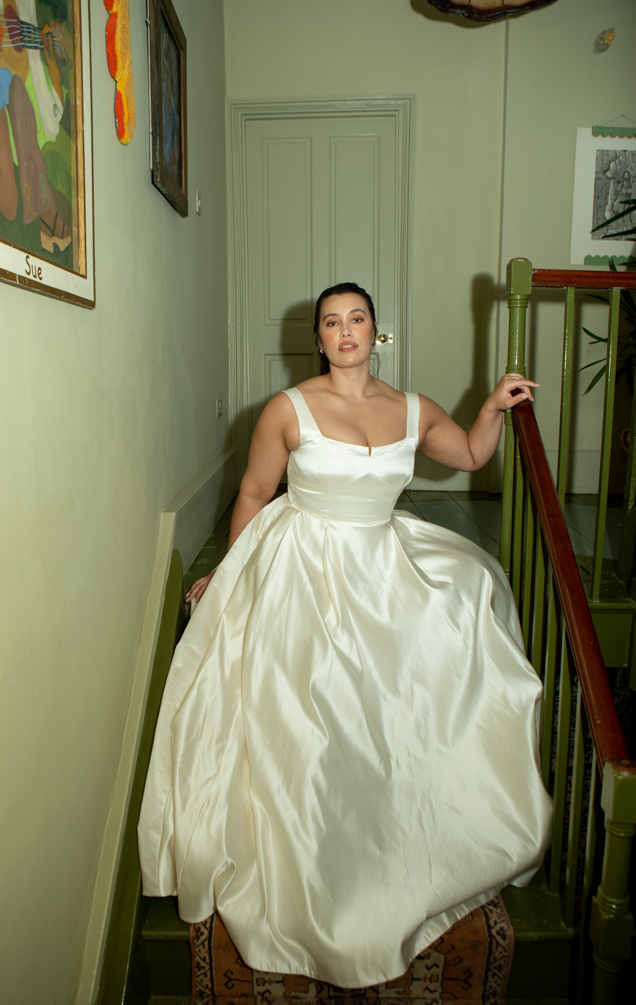 Plus size model wearing timeless wedding dress by Andrea Hawkes Bridal