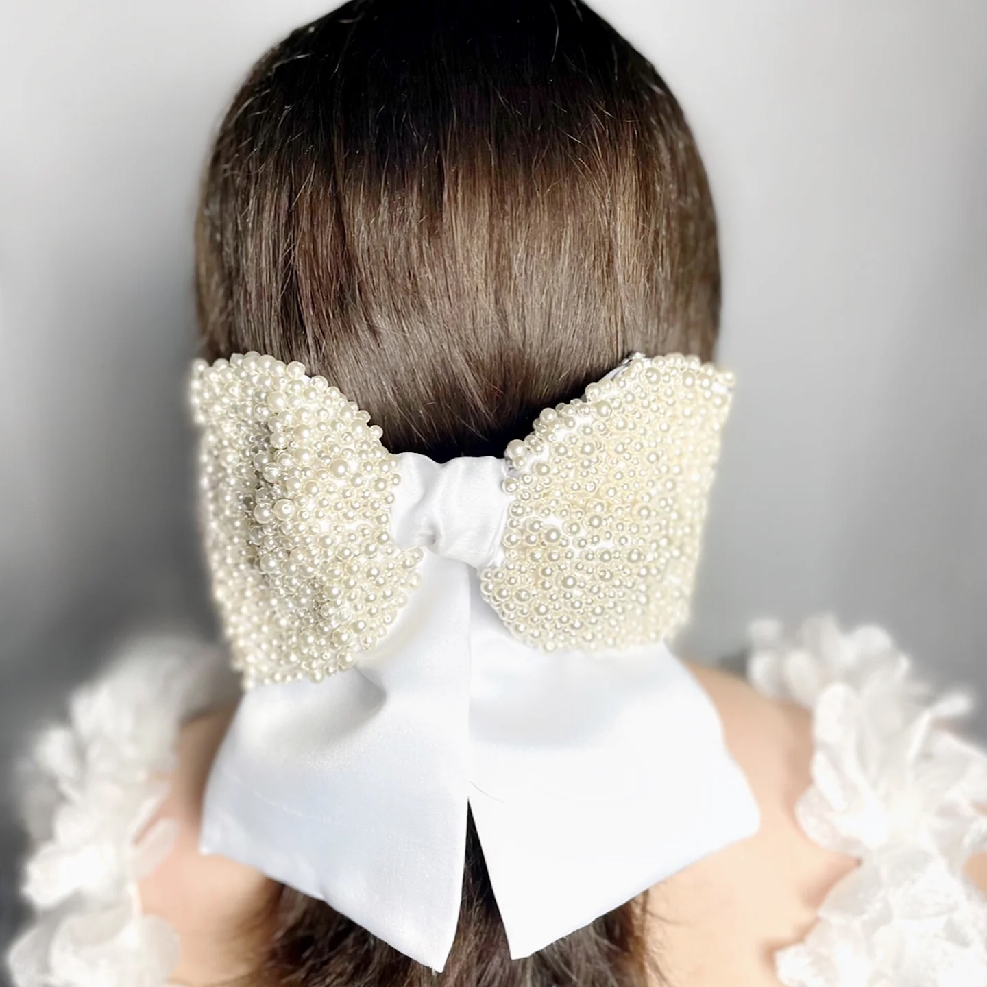 Large pearl bridal bow worn at the back of the head. The Kindness Bridal Bow, by Camille