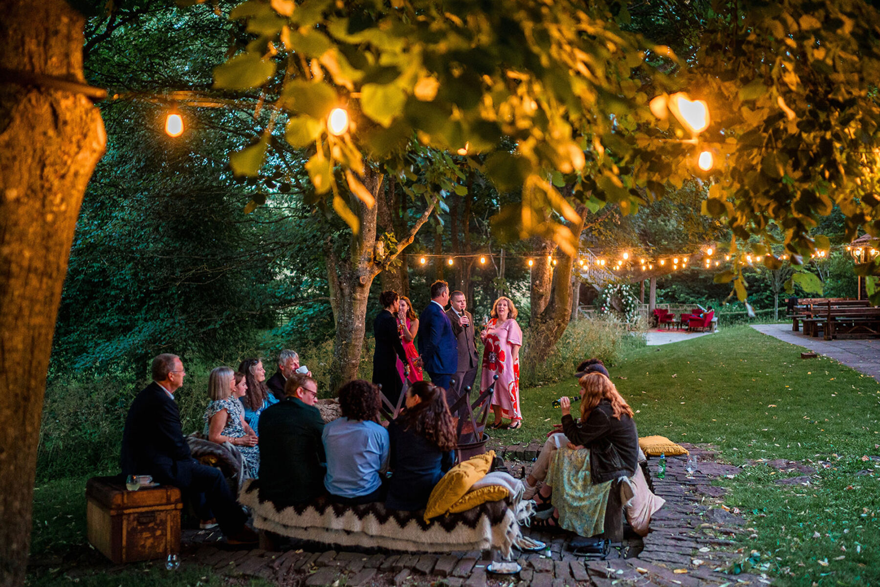 Cocktails beneath the treehouse at Dewsall Court, country house wedding venue in Herefordshire