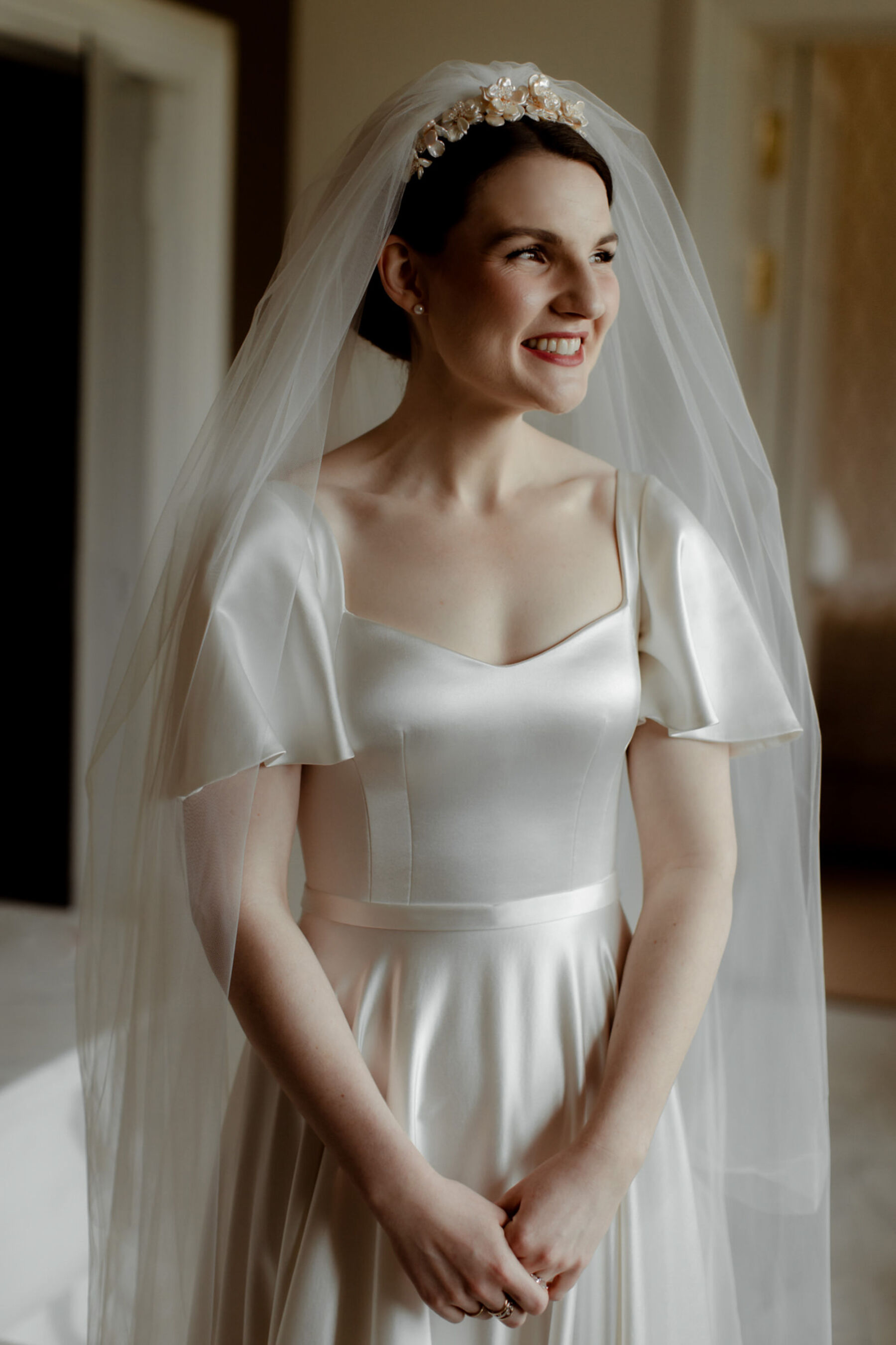 Bride with red lipstick wearing an elegant & minimalist Andrea Hawkes Bridal silk wedding dress.