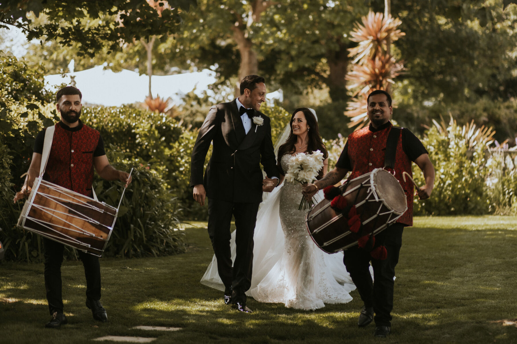 Drummers entertaining the bride and groom at The Pennsylvania Castle Estate - a Dorset wedding venue on a clifftop with incredible sea views.