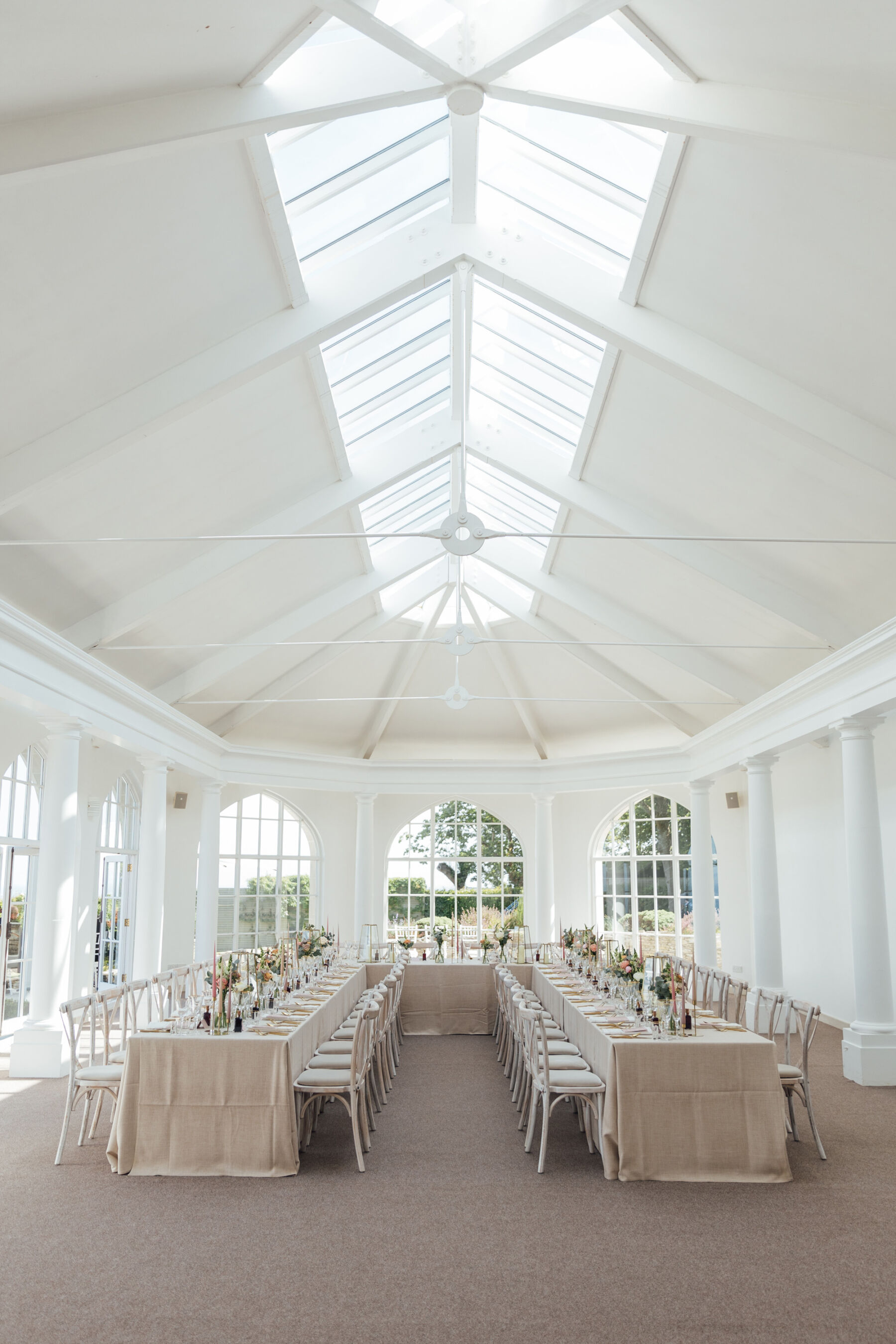 Inside the spacious and light filled reception room at The Pennsylvania Castle Estate - a Dorset wedding venue on a clifftop with incredible sea views.