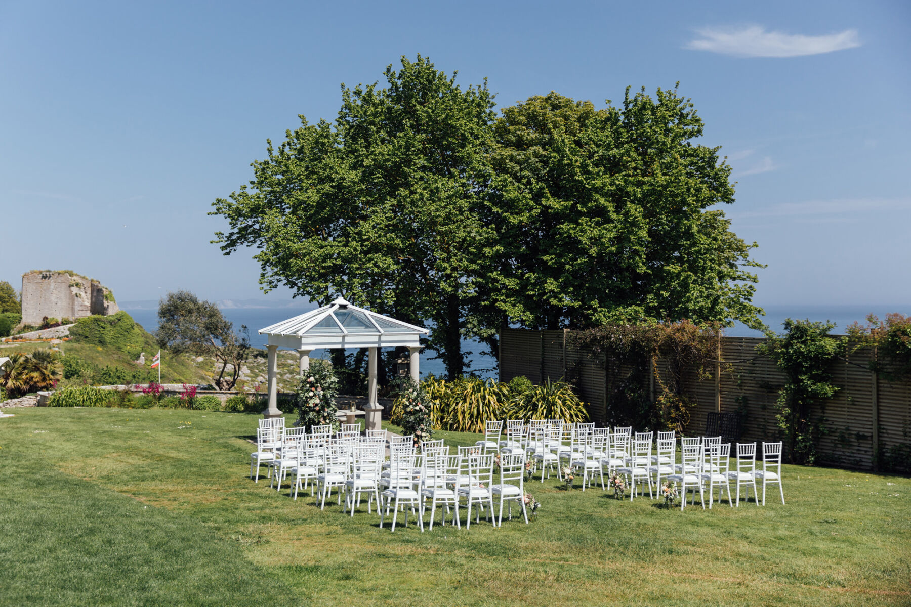 Outdoor wedding ceremony setup at The Pennsylvania Castle Estate - a Dorset wedding venue on a clifftop with incredible sea views.