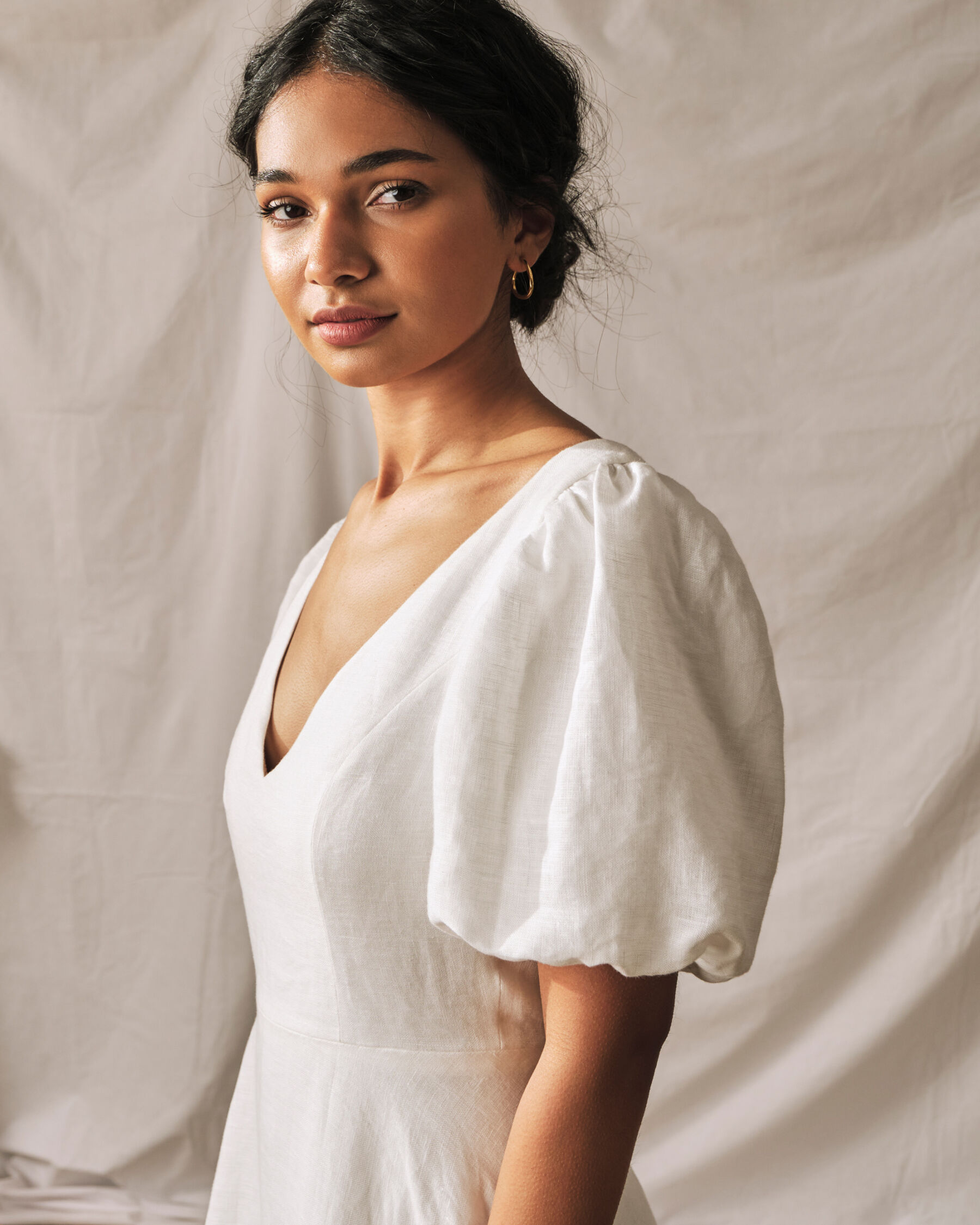 Upper half of a simple wedding dress with a gentle puff sleeve, by Sophie Rose Bridal.