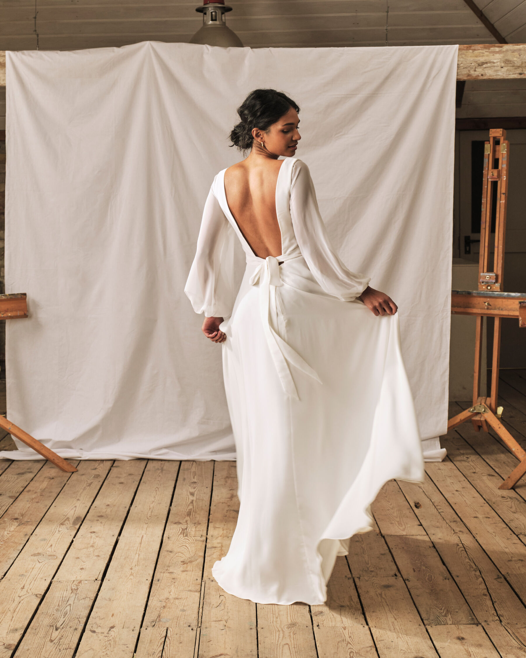 Simple modern wedding dress by Sophie Rose Bridal. No train but enough fabric to make a swish. Backless.