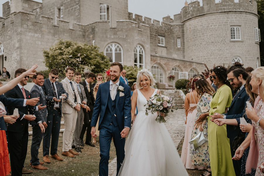 Bride and groom just married at an outdoor ceremony at The Pennsylvania Castle Estate - a Dorset wedding venue on a clifftop with incredible sea views.