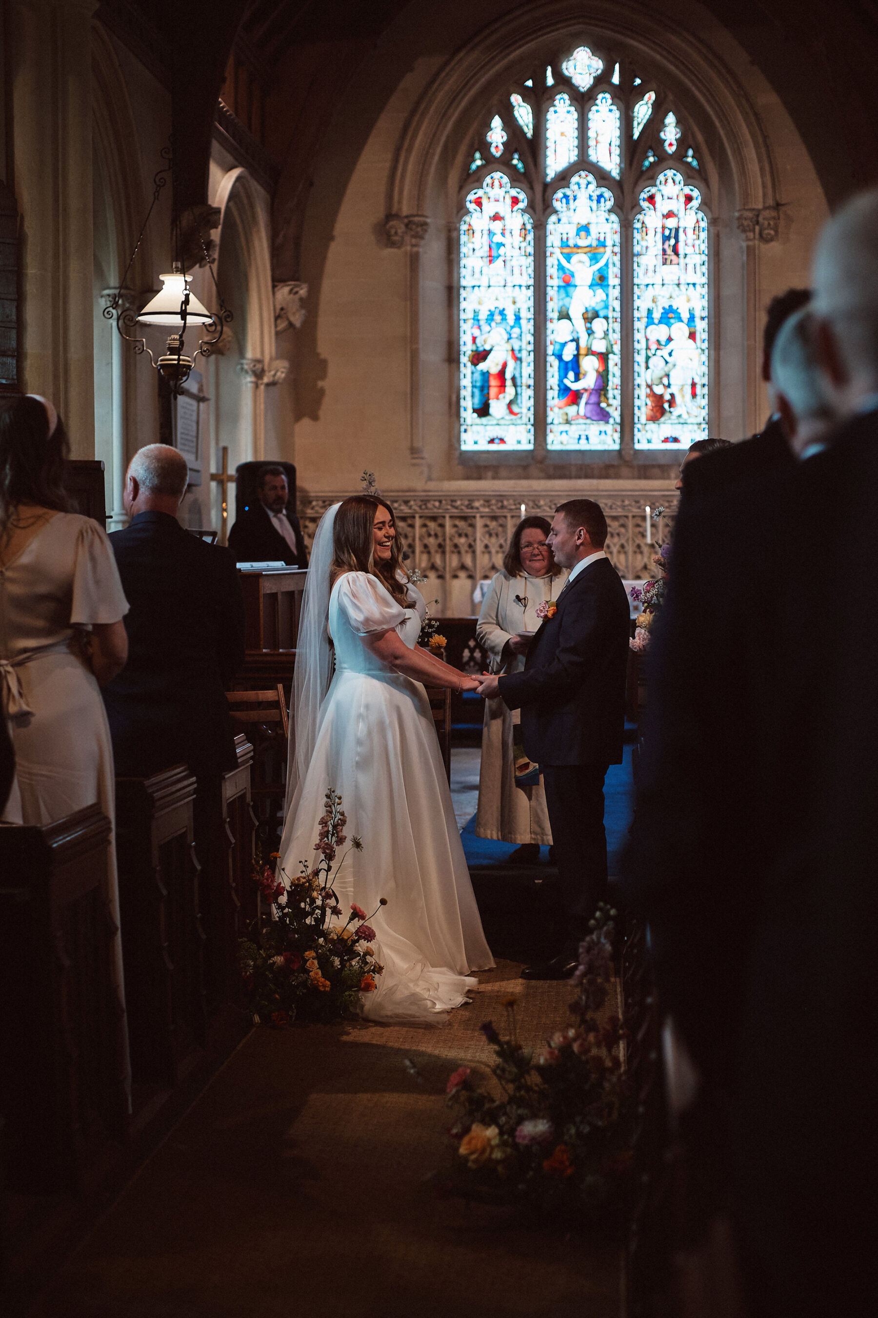 Bride and groom holding hands during their church wedding ceremony.