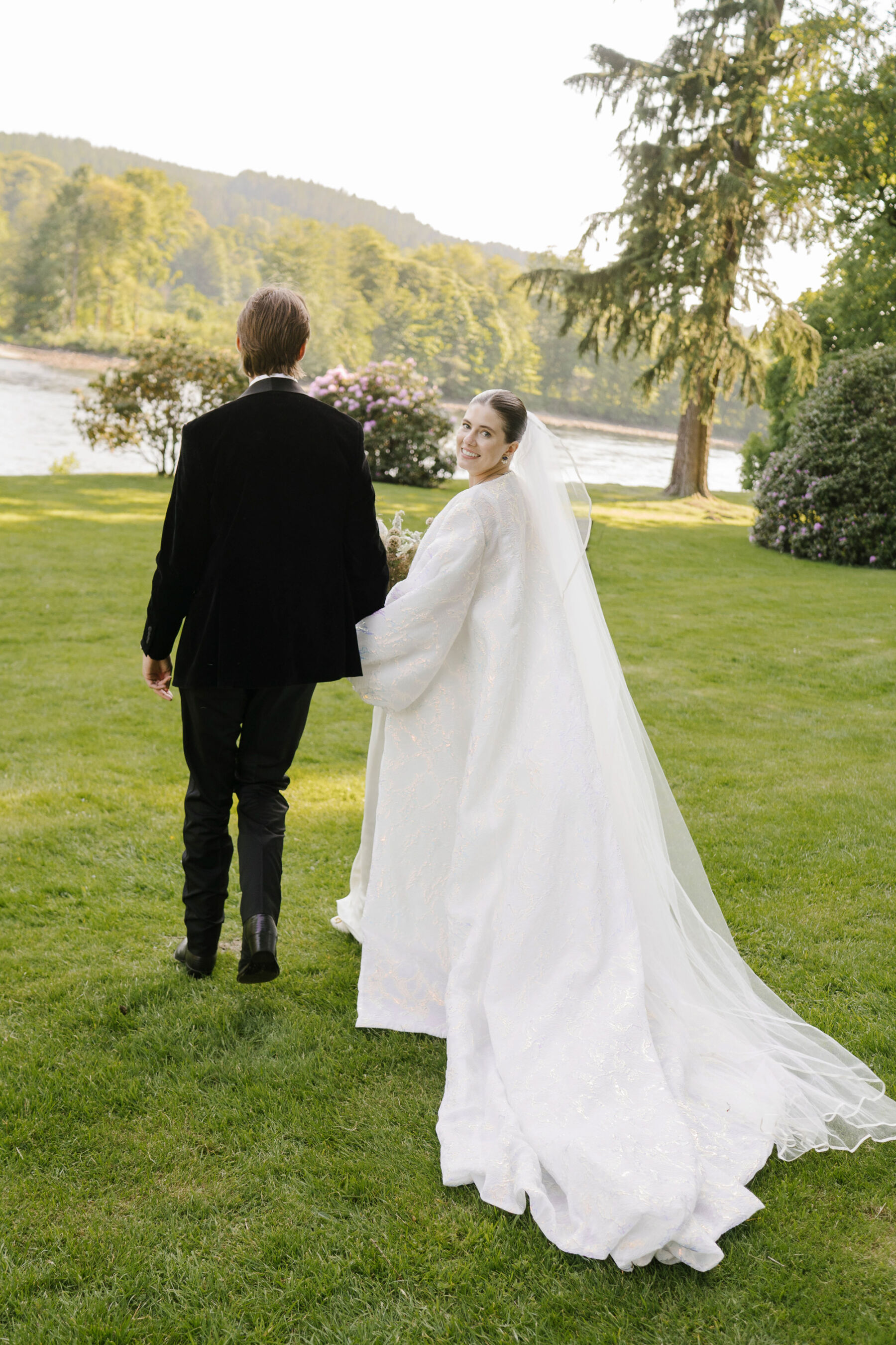 Bride wearing a statement wedding coat by Jesus Peiro.