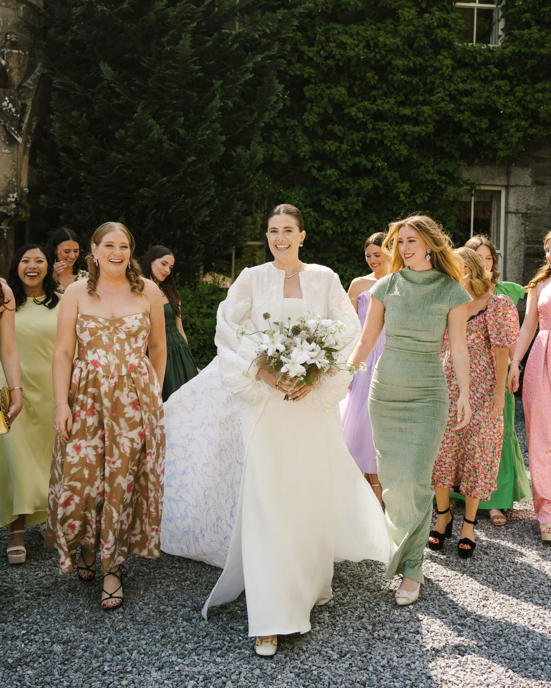 Modern bride wearing The Row, and a bridal coat by Jesus Peiro