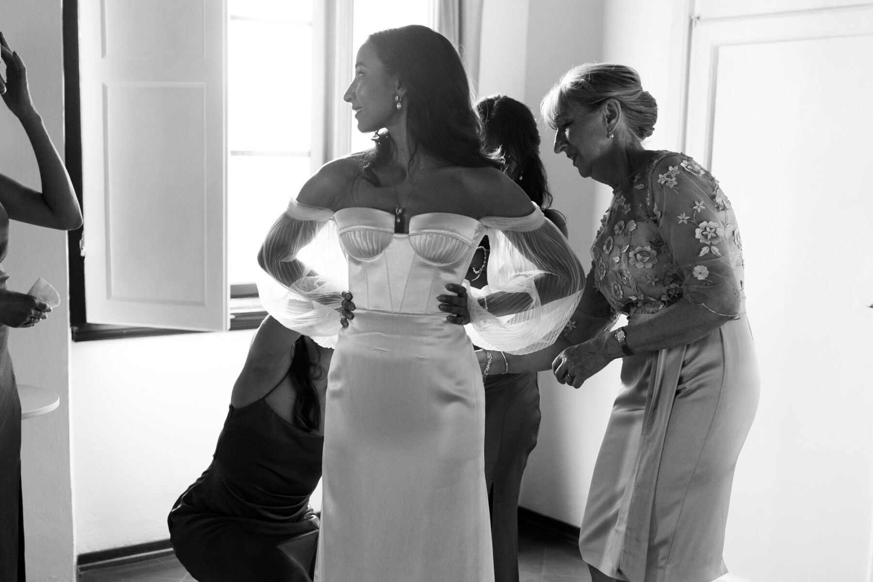 Bride wearing an Alena Leena wedding dress. Off the shoulder gown with cupped breast and floaty, detachable tulle sleeves.
