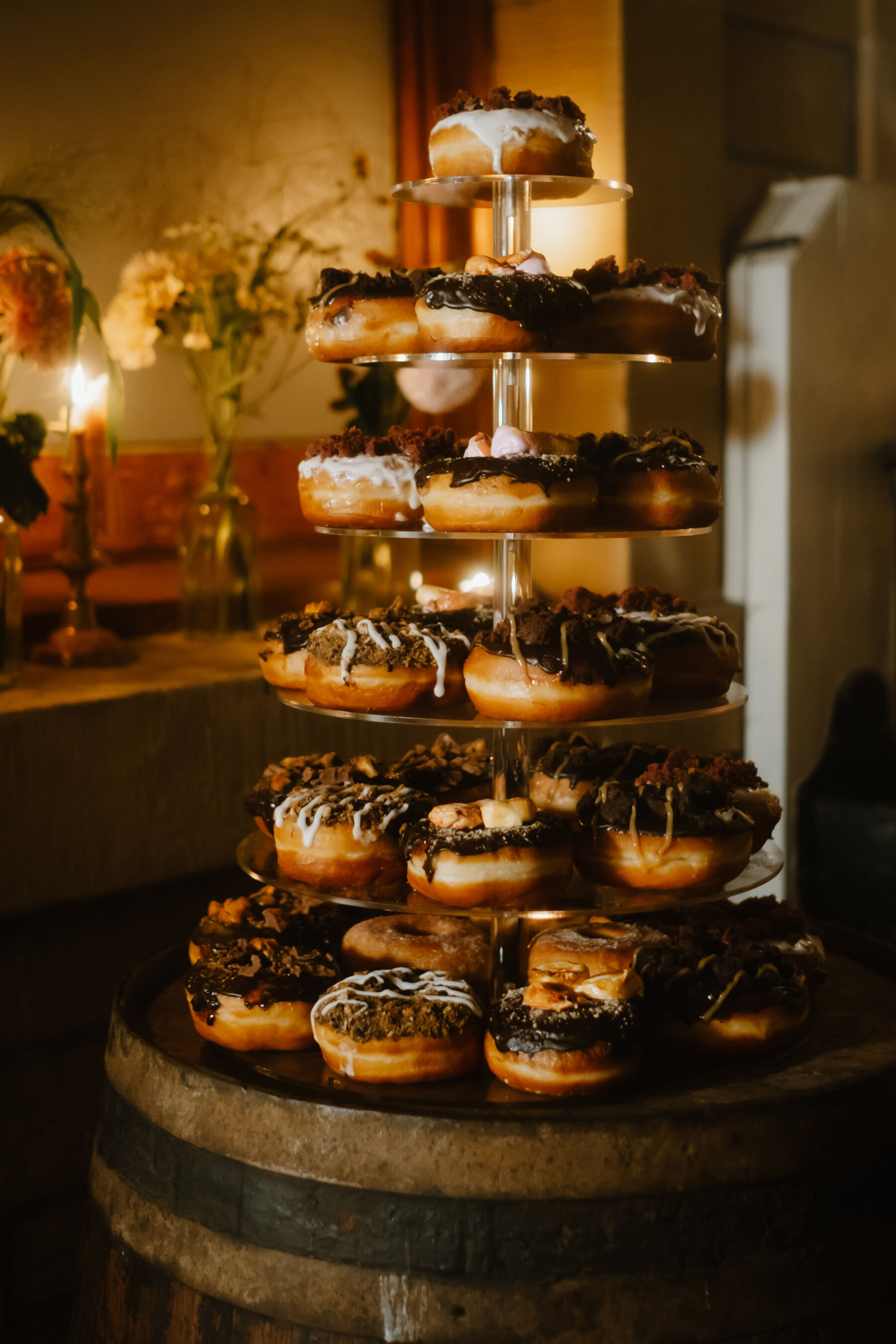 Wedding doughnuts on a tiered cake stand.