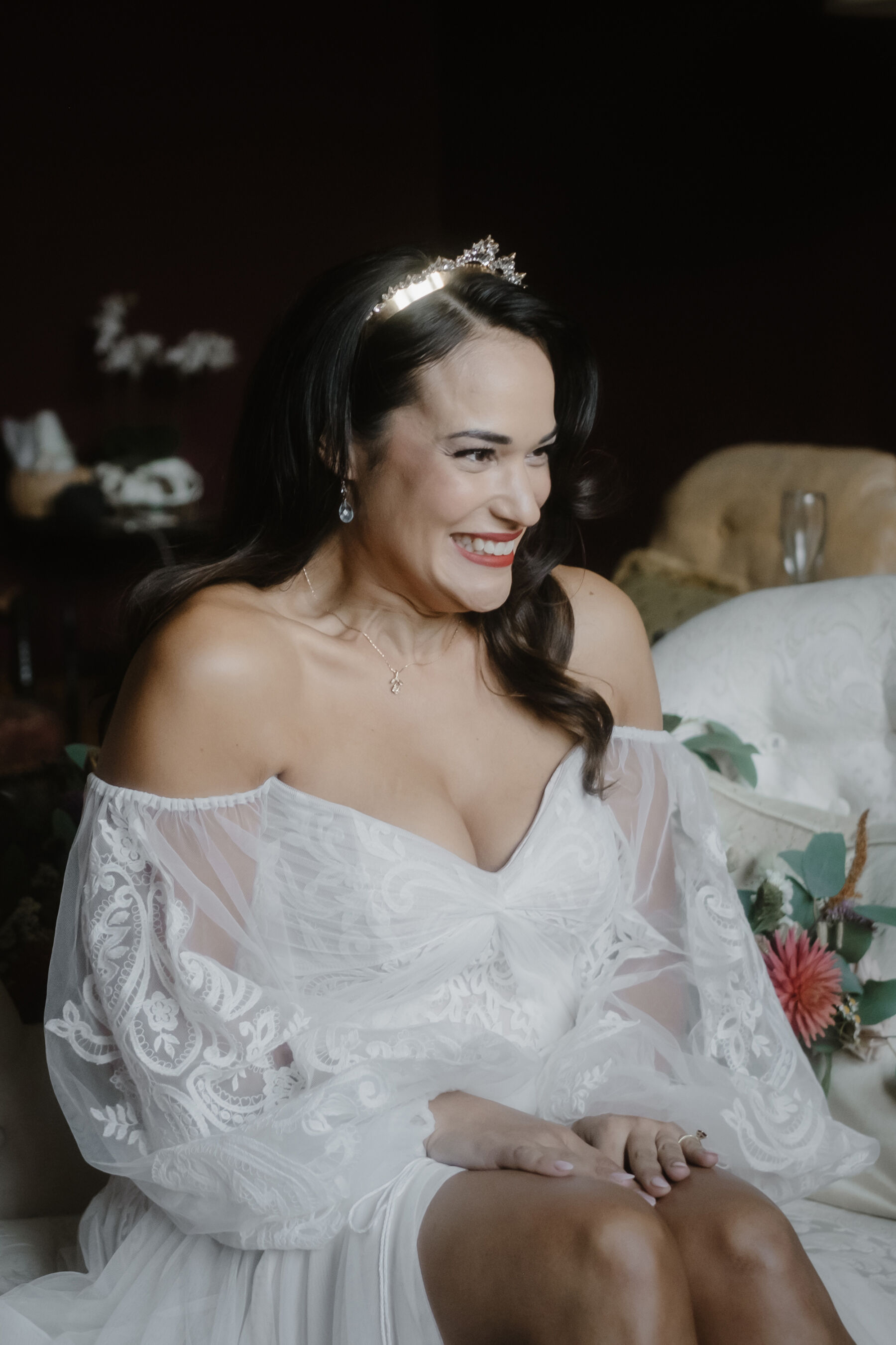Smiling happy bride wearing a Lelet bridal headpiece & off the shoulder bohemian inspired wedding dress by Willowby by Watters.