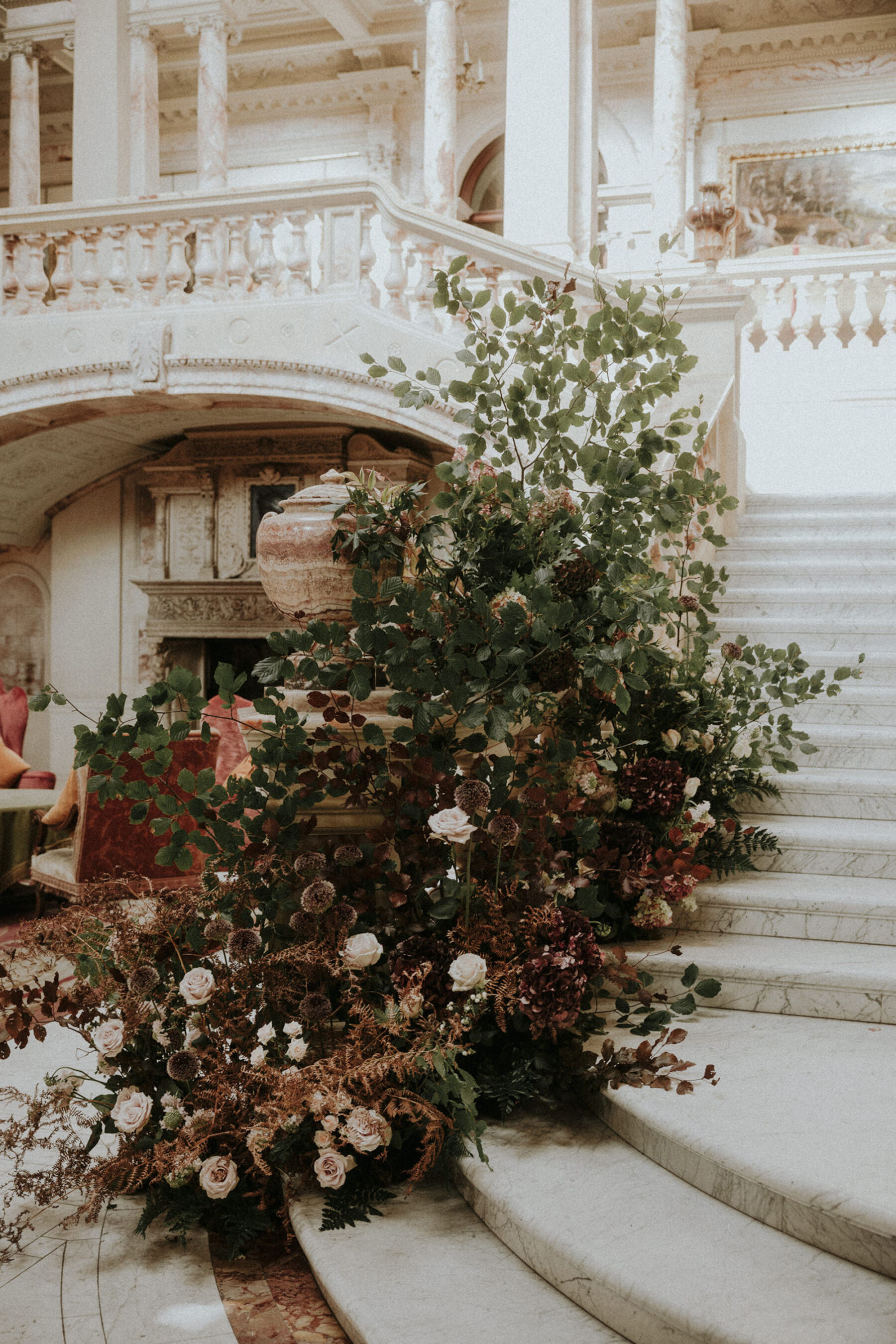 Staircase at Gosford House decorated with flowers and greenery for a wedding.