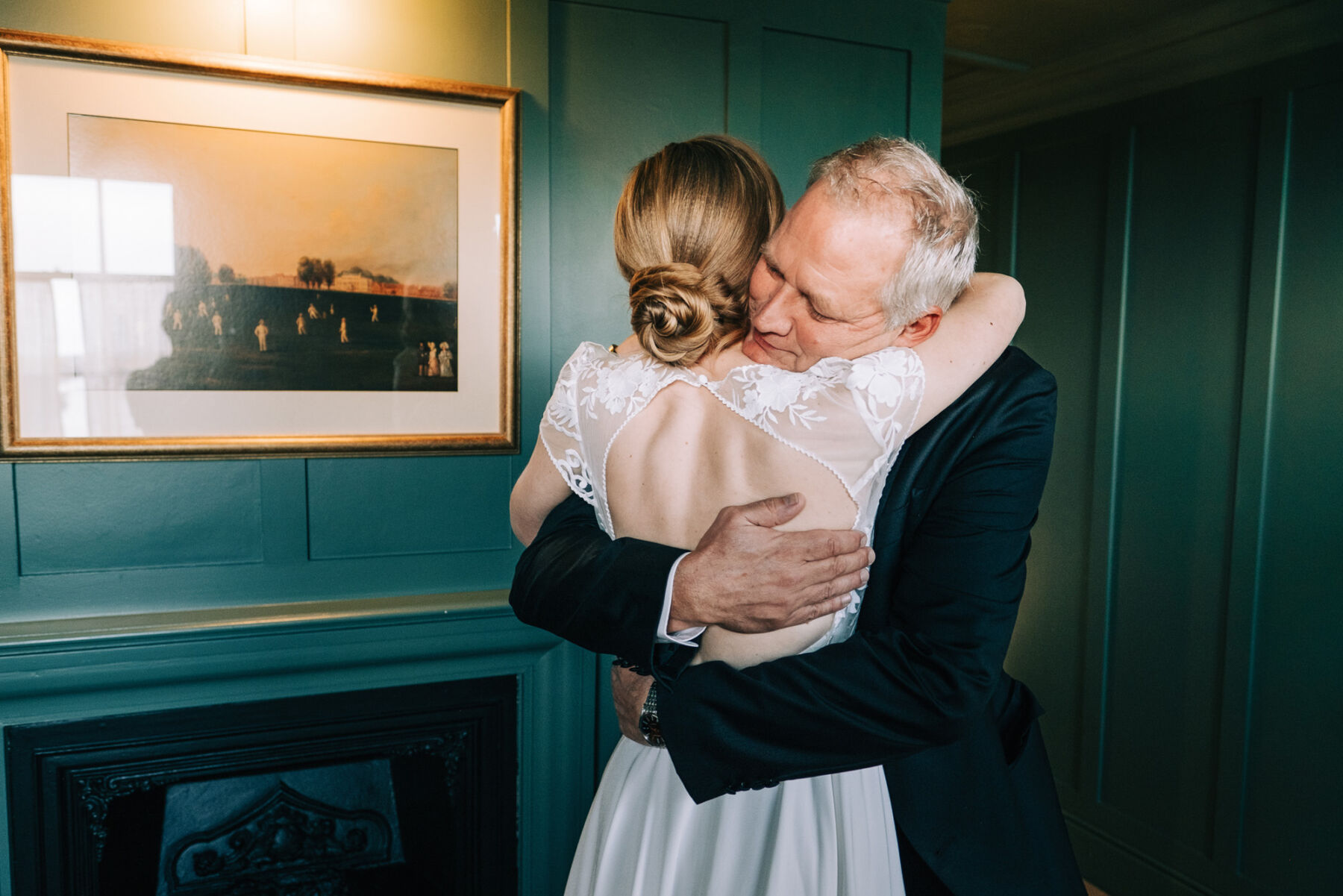 Father of the bride embracing his daughter in her Rembo Styling wedding dress.