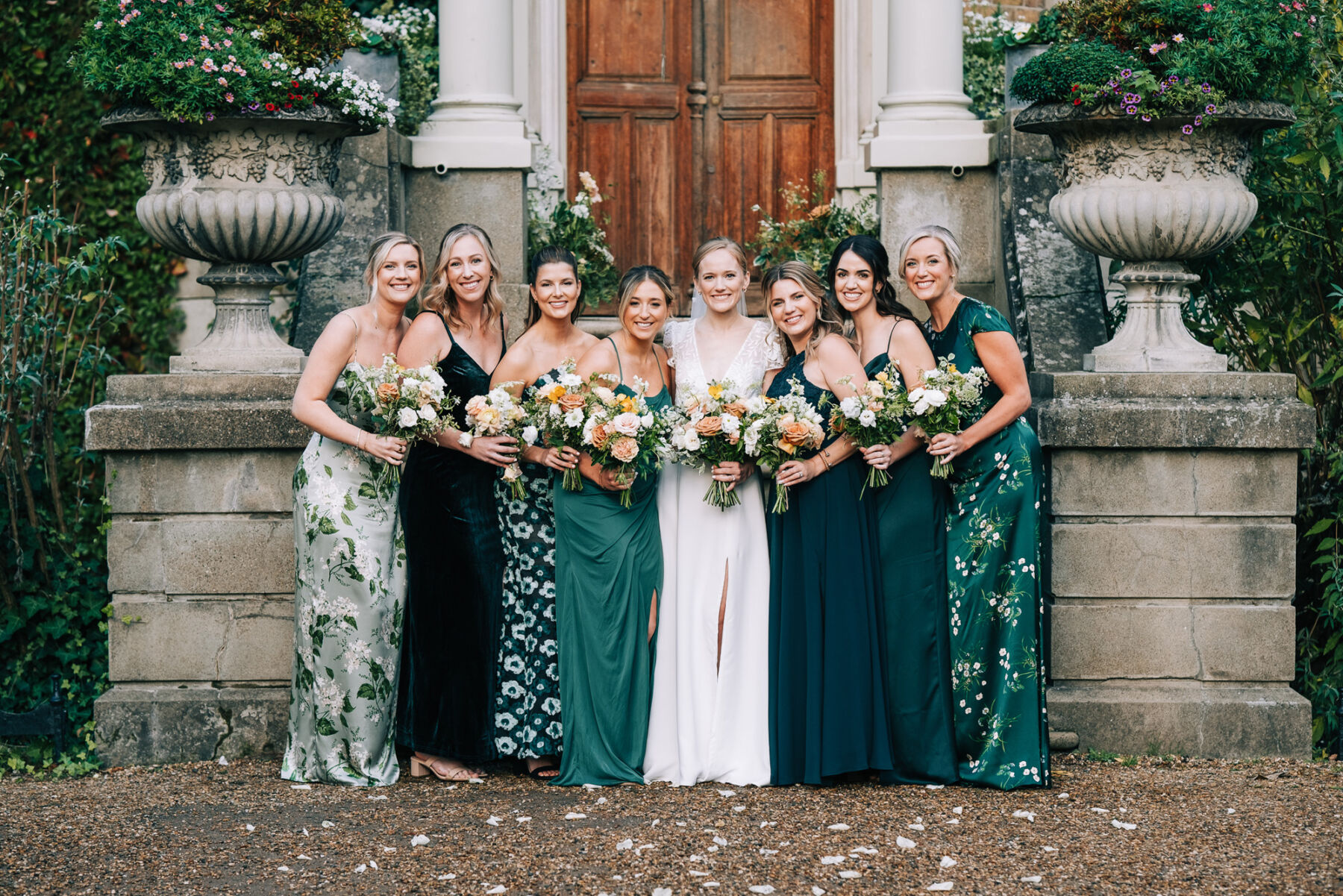Bride wearing Rembo Styling wedding dress with her bridesmaids in various style green dresses. Hampton Court wedding.