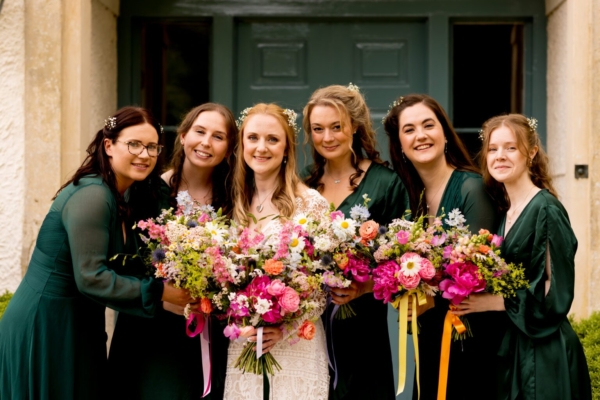 bride surrounded by her bridesmaids in green dresses - Jessica Hayman, Hampshire wedding photographer