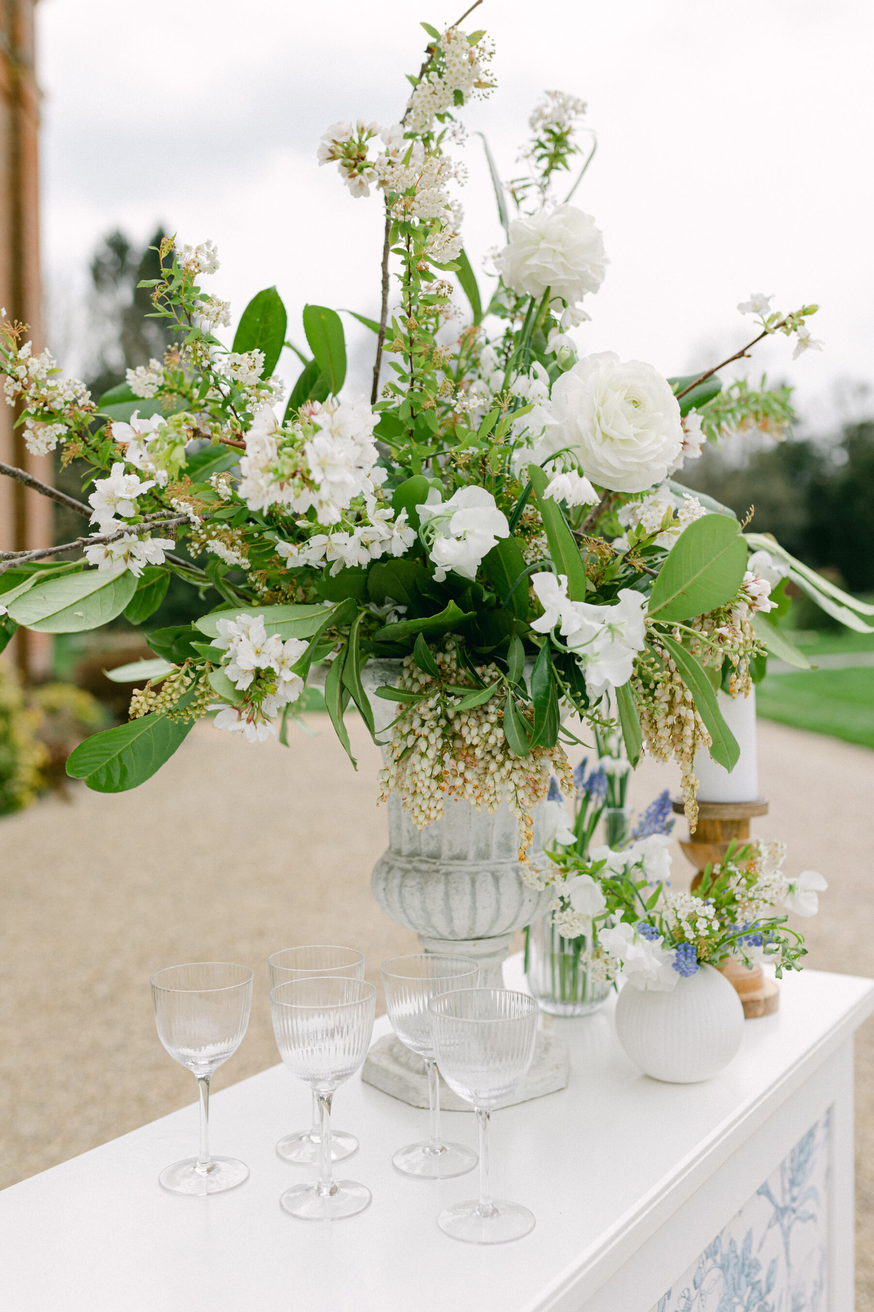 Elegant all white wedding flowers styled on a mobile wedding bar.