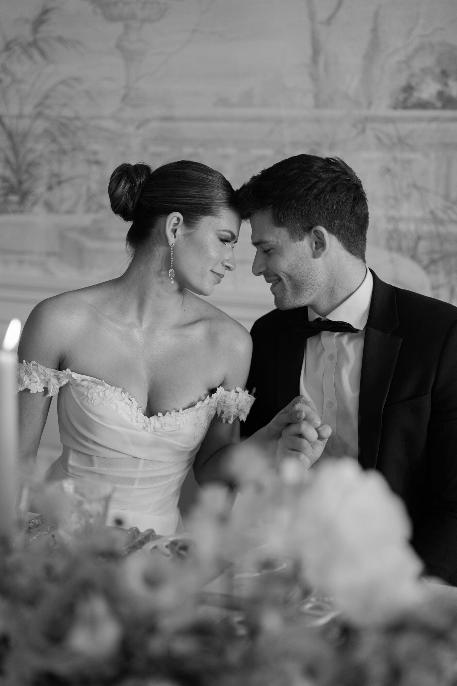 Black & white photography of model bride and groom touching foreheads and looking lovingly into one another's eyes. Kamila Nowak Photography.