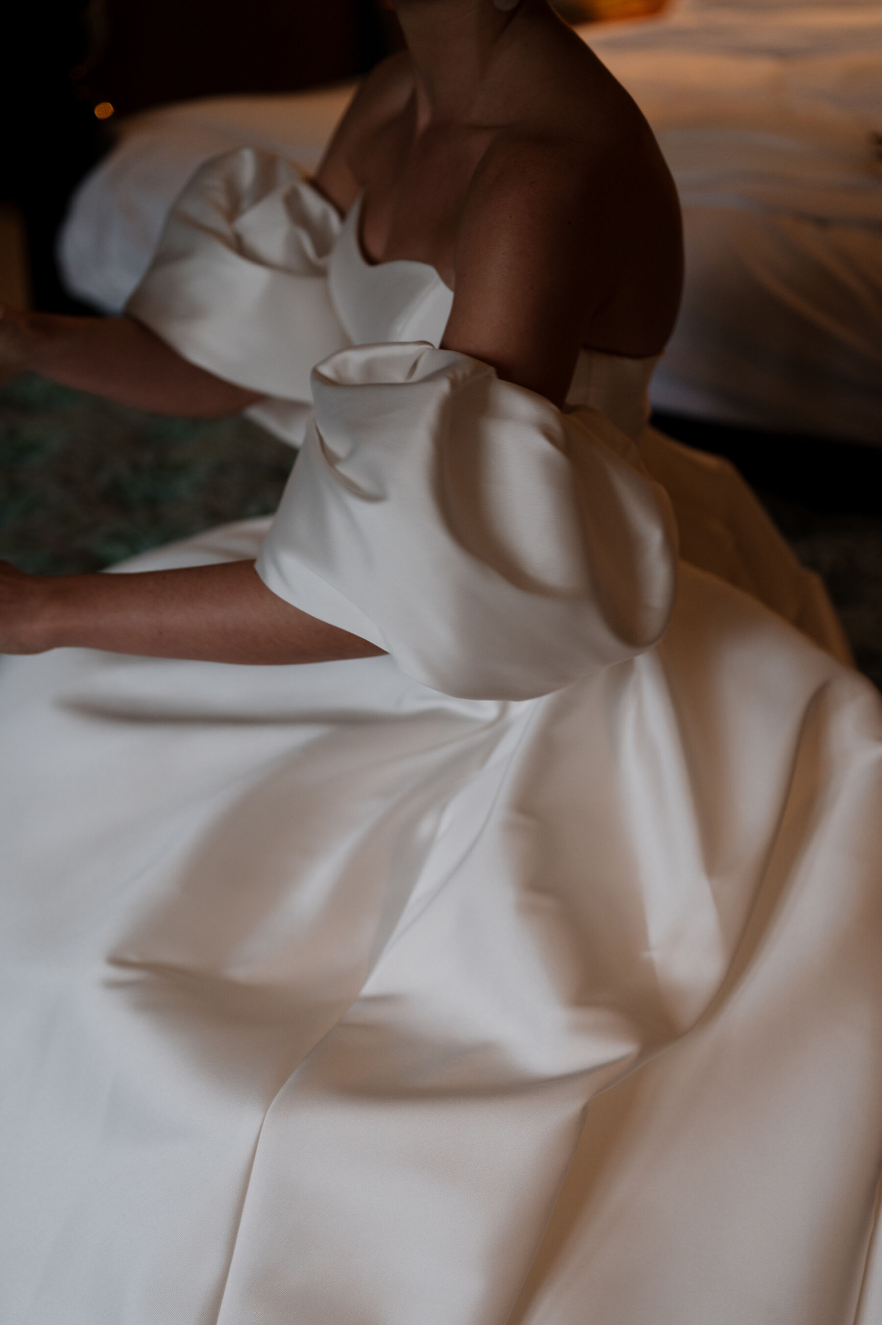 An Elegant Black Tie Wedding at Hampton Manor in Birmingham, with a Badgley Mischka Gown 26 Bride wearing a Badgley Mischka wedding dress with removable puff sleeves. She carries a white wedding bouquet. Taylor Hughes Photography.